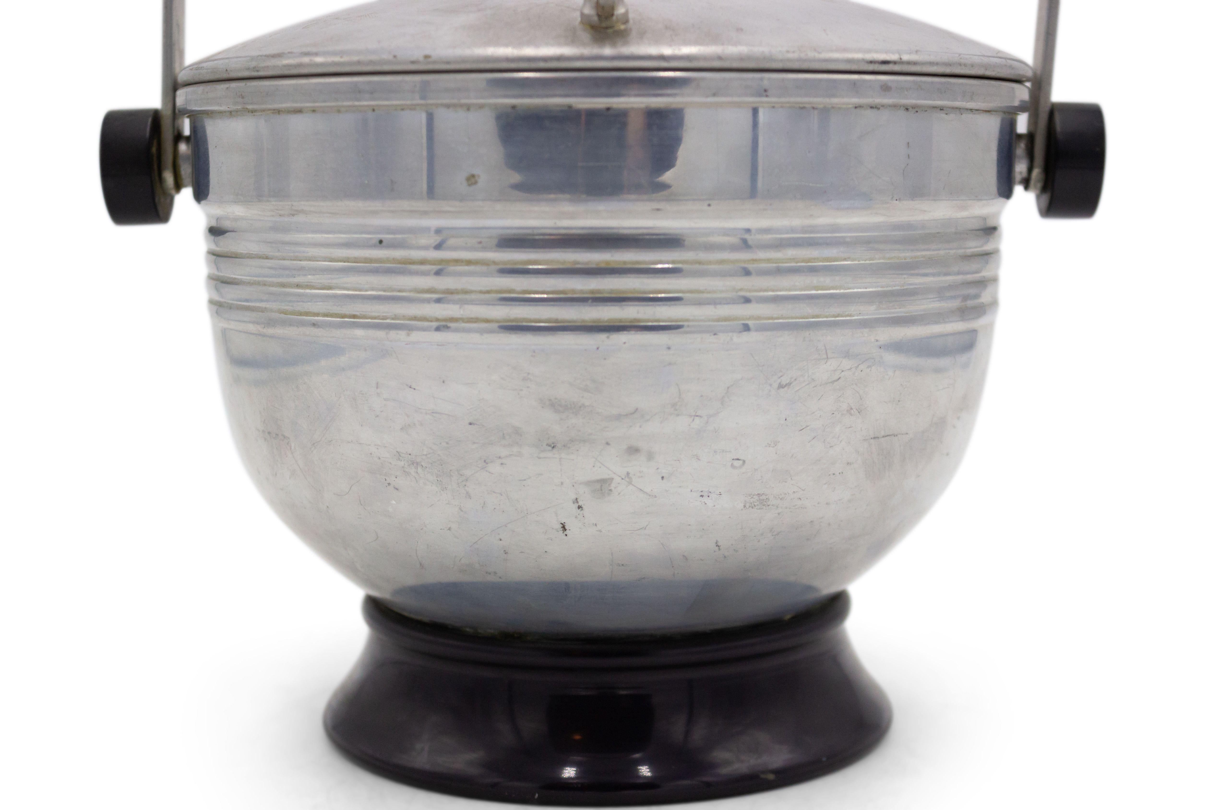 American Art Moderne (20th Century) aluminum ice bucket with lid and handle and bakelite base.