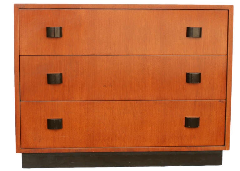 Art Moderne dresser set of two by Gilbert Rohde. This low boy dresser features a walnut finish with a black lacquer floating base completed with decorative streamline black lacquer.