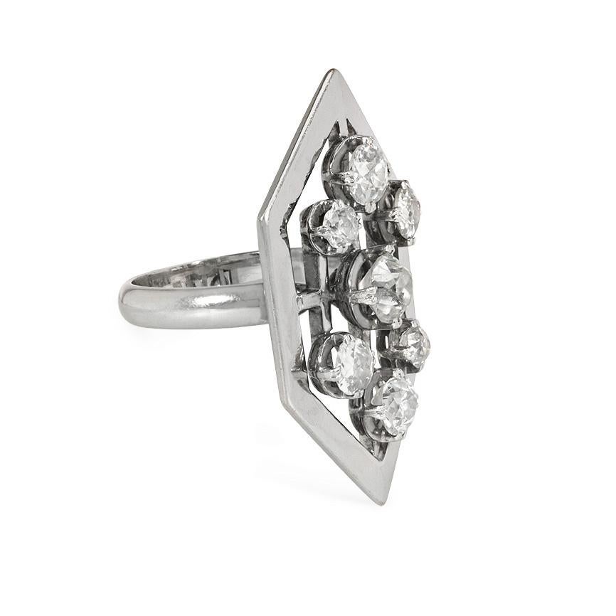 A large scale Art Moderne statement ring designed as an elongated open hexagonal plaque set with seven old European cut diamonds, in platinum and 18k gold. French import marks.  Atw 3.94 cts. (center stone approximately 1.27 ct.)

* Free one-time