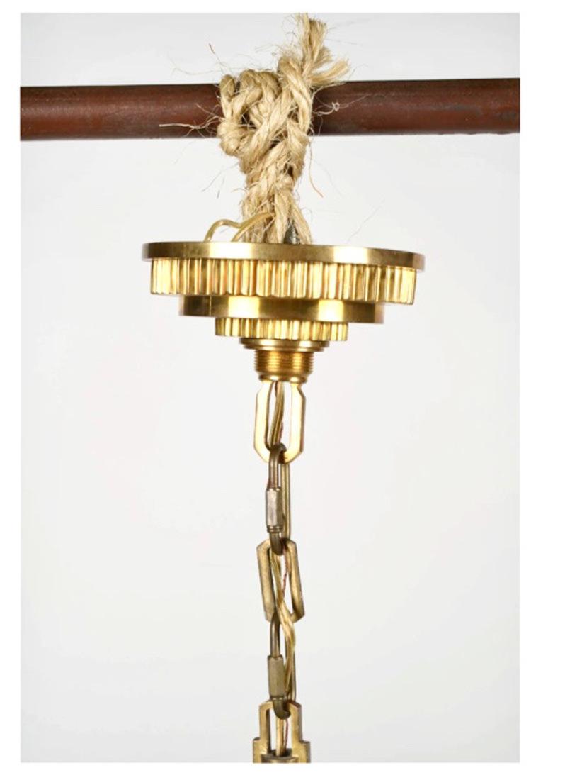 This is a very chic and sophisticated small gilt bronze chandelier in an Art Deco/Art Moderne style. The chandelier is beautifully cast and gilded. It would be the perfect addition to a masculine study or man's dressing room, an entrance or even a