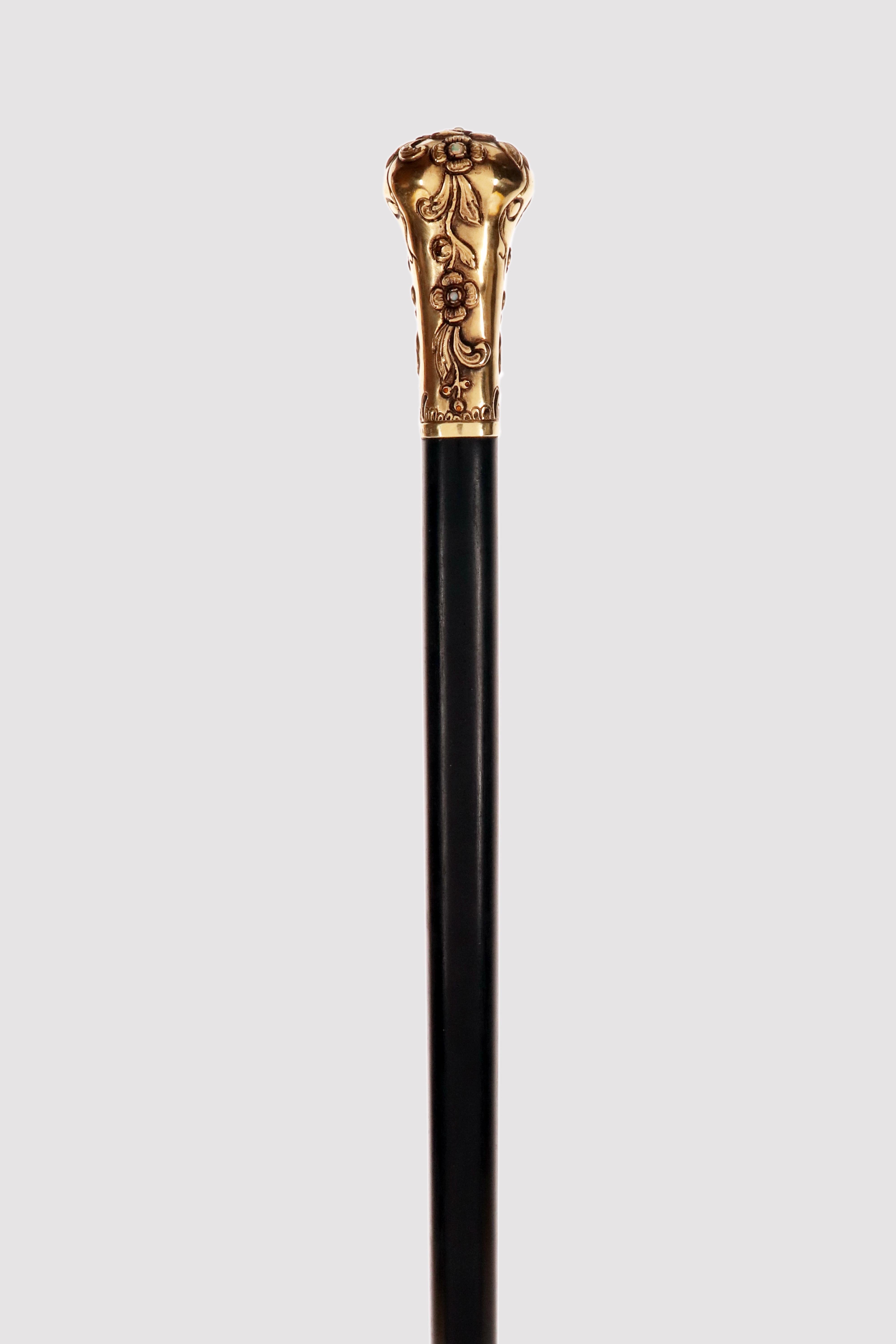 Art Nouveau walking stick: gilded silver knob in the shape of a milord depicting flowers in relief with cabochon opal stones and diamont-cut yellow sapphires. Ebony wood shaft. Metal ferrule. Signed Henri-Victor Miault (1881-1960). A carver and