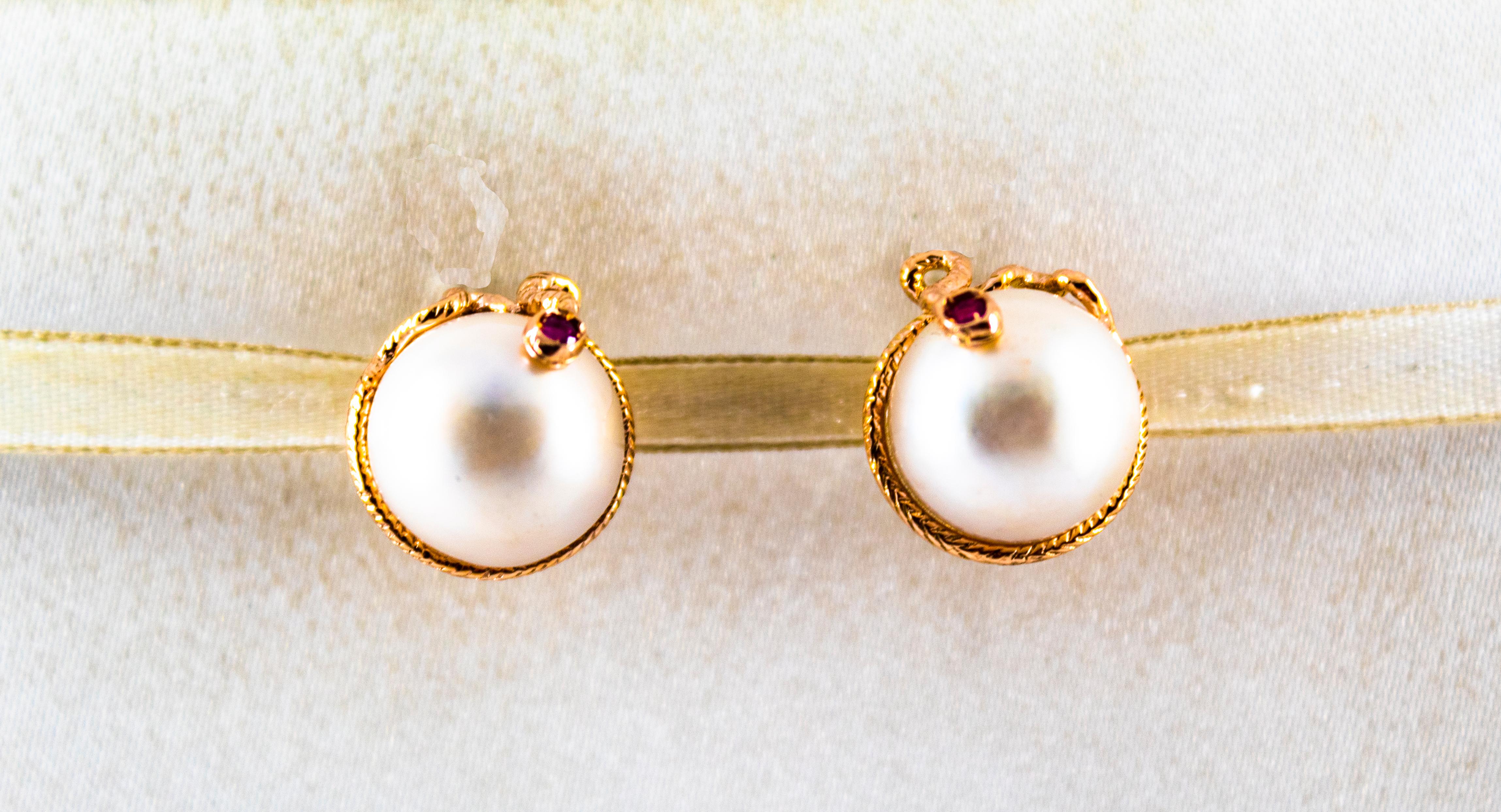 These Earrings are made of 9K Yellow Gold.
These Earrings have 0.12 Carats of Rubies.
These Earrings have two Mabe Pearls.
These Earrings are inspired by Art Nouveau.
These Earrings are available also in a smaller version or with Stud.
All our