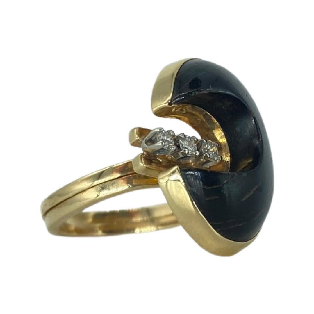 Art Nouveau 0.15 Carat Diamond Black Tiger Eye Moon Cut Double Cocktail Ring. The ring features a one of a kind moon cut design black tiger's eye that measures 19mm X 13mm and with three round cut diamonds in between the stone that weights approx