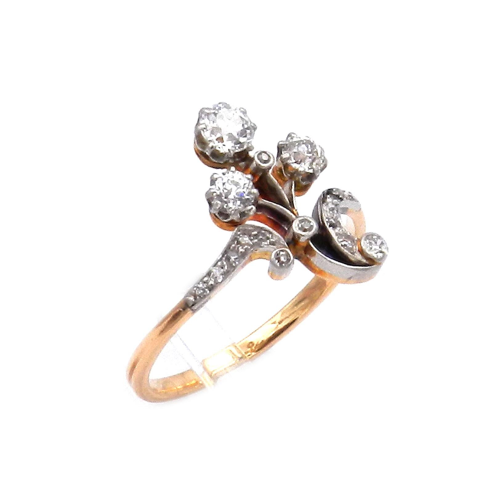 Art Nouveau 0.75 Carat Diamond Gold and Platinum Flower Ring circa 1910

Decorative Art Nouveau diamond ring as an elegantly intertwined flower, set with four diamonds totaling 0.7 ct, the curved leaves set with ten additional small diamonds. As was