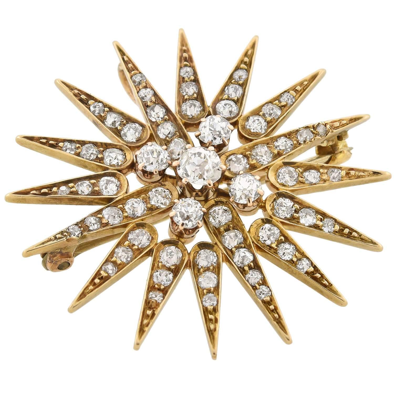 A spectacular diamond starburst pin/pendant from the Art Nouveau (ca1900s) era! This beautiful piece is crafted in 14kt yellow gold and comprised of 61 old Mine Cut diamonds which come together to form a sparkling celestial starburst. Five diamonds