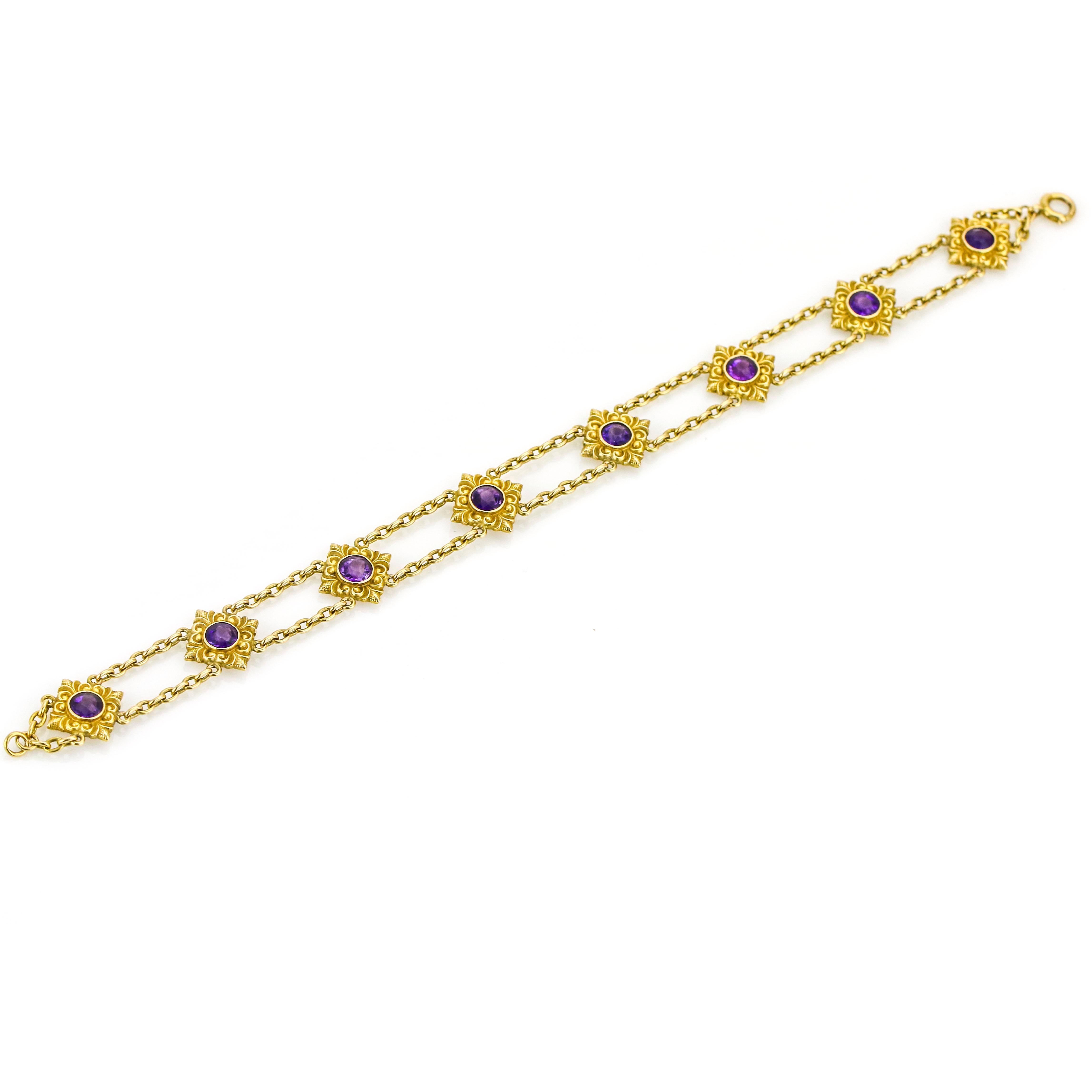 Art Nouveau bracelet in 14 karat yellow gold. The bracelet has 8 stations that are connected through a double chain. Each station is bezel set with a round Amethyst. The stations have intricate detail reminiscent of the period.

Width, 13.5 mm.