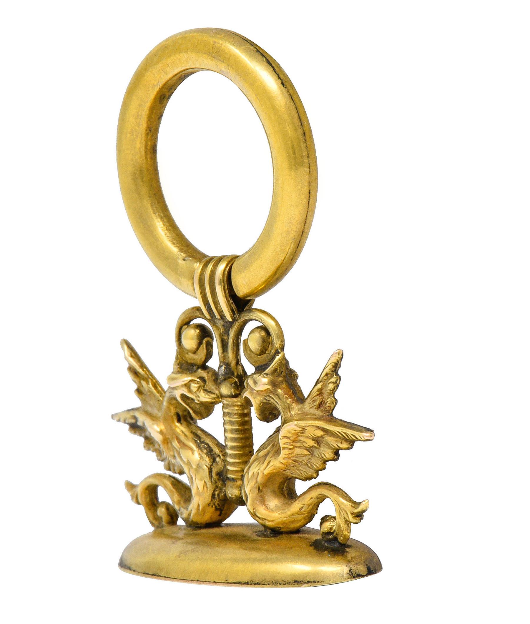 Fob is designed with two mirrored wing serpents

Highly rendered with whiplash tails and S curved bodies

With an oval fob base inscribed with monogramed lettering

Completed by a large doorknocker style bale

Tested as 14 karat gold

Circa: