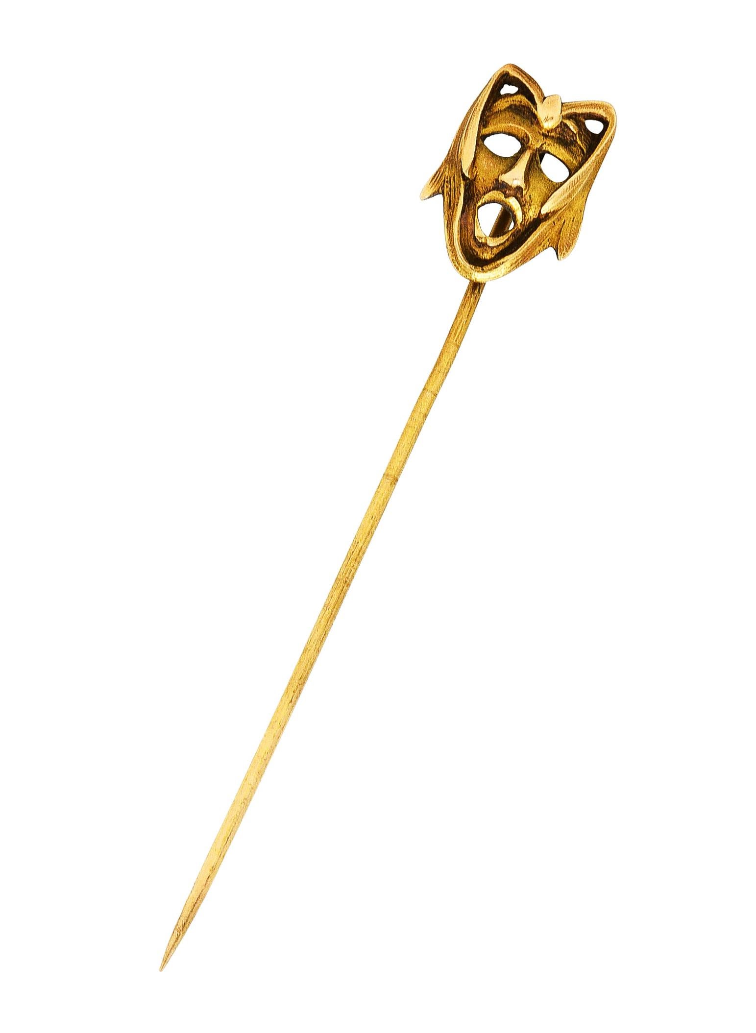 Stickpin is designed as stylized mask of Green Man figure

With expressive features and leafy fronds framing face

Completed by pinstem

Tested as 14 karat gold

Circa: 1905

Head measures: 1/2 x 11/16 inch

Total length: 2 7/8 inches

Total weight: