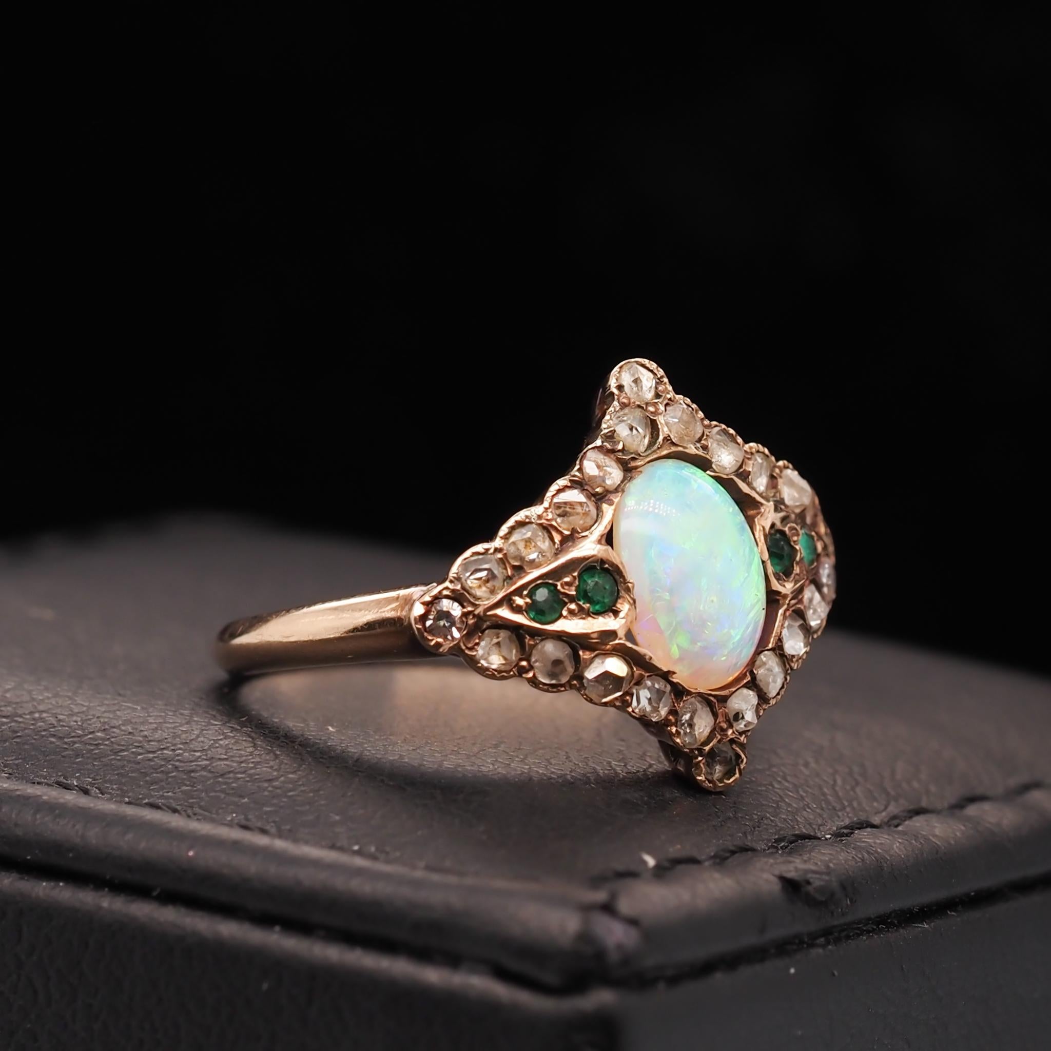 Year: 1900s

Item Details:
Ring Size: 6
Metal Type: 14K Yellow Gold [Hallmarked, and Tested]
Weight: 2.7 grams

Diamond Details: .25ct total weight, rose cut diamond, natural diamonds, I/J Color, VS clarity

Center Stone Details: Australian Opal,