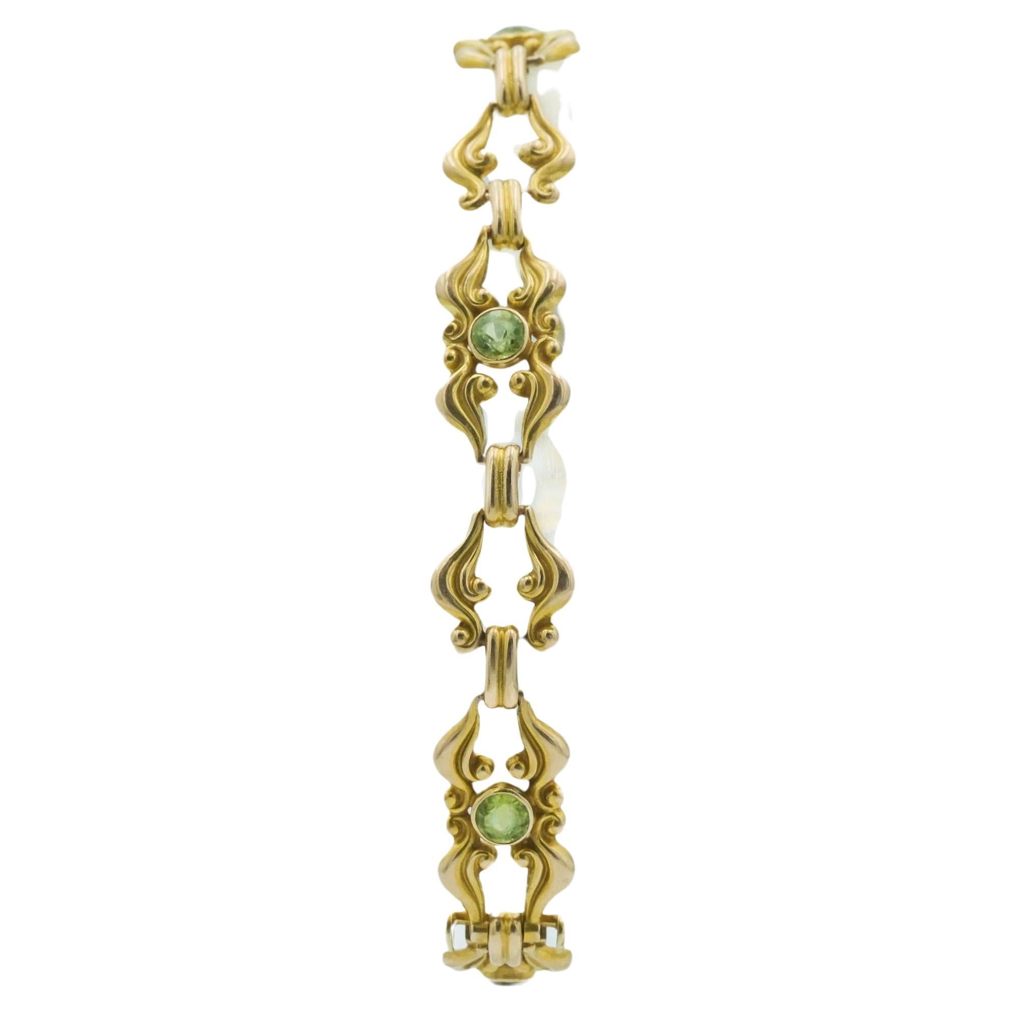 Bracelet à maillons Art nouveau en or jaune 14 carats avec volutes et pierres précieuses vertes