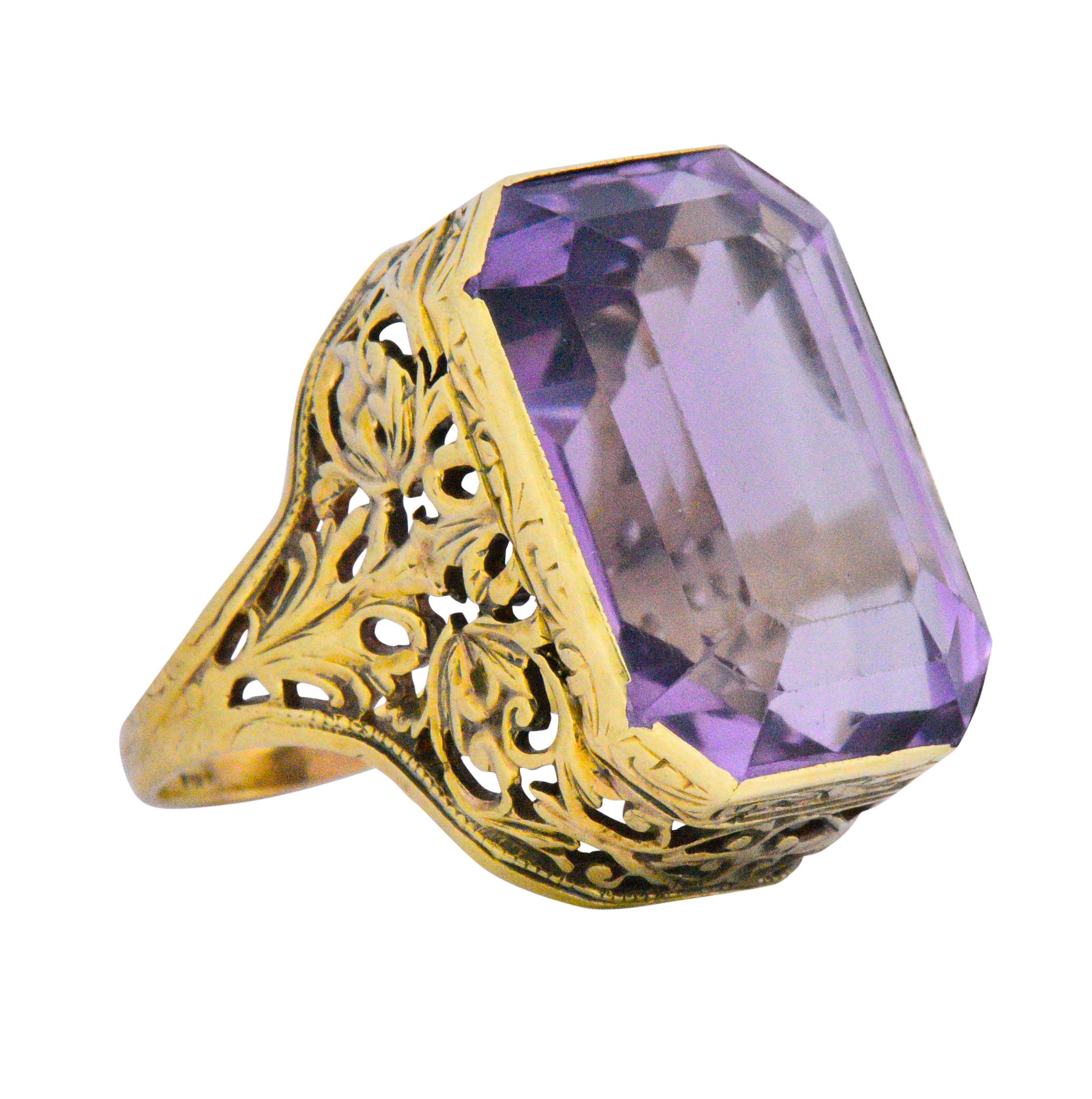 Centering a emerald cut amethyst weighing approximately 14.00 carats total, lovely light bright even purple

The amethyst is bezel set in a well, simply stunning pierced filigree gallery, with scrolling a foliate motif details 

The perfect cocktail