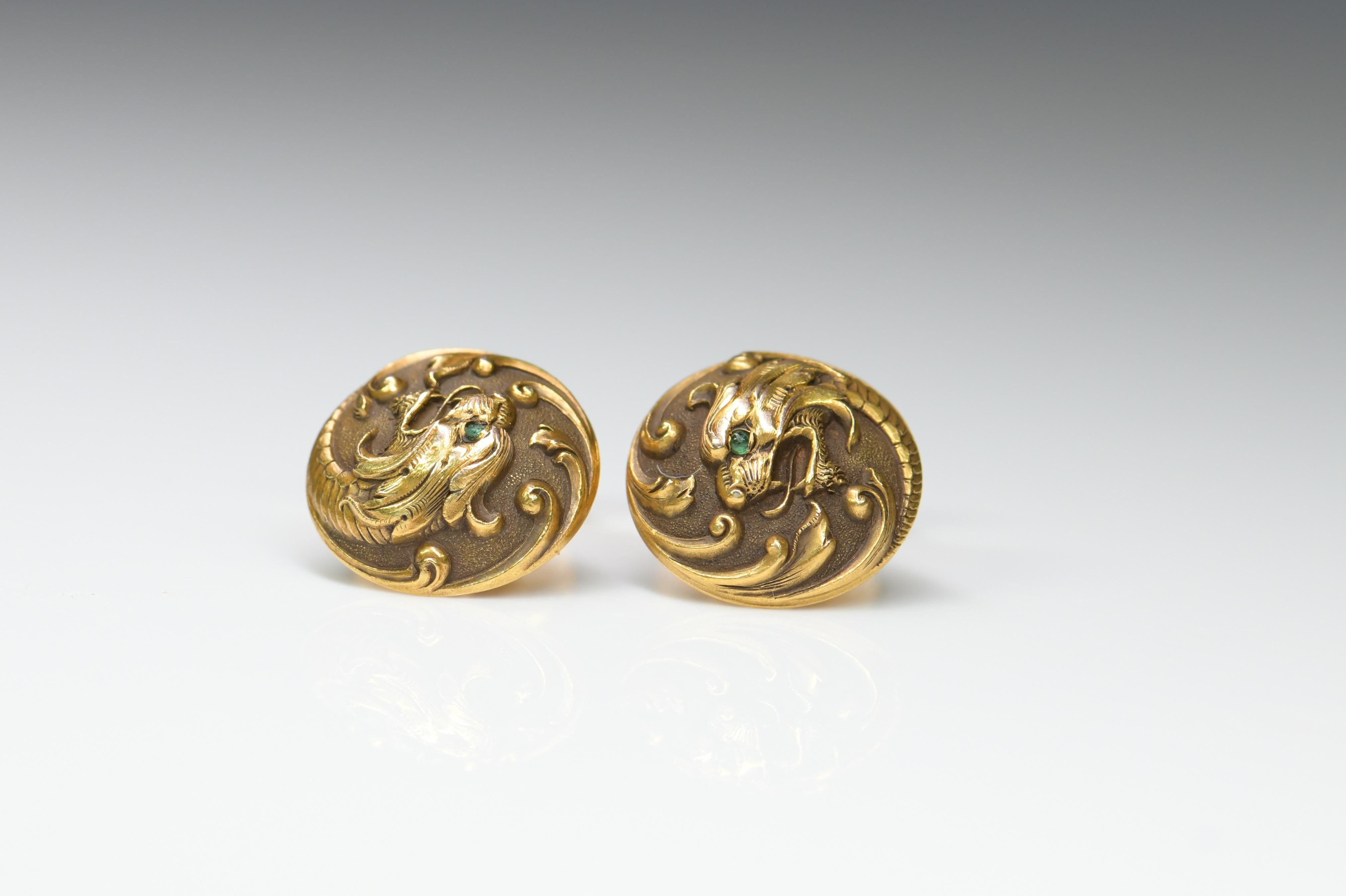 A rare pair of Art Nouveau 14ct gold cufflinks. The gold work is incredible fine. They are fine models of a dragon's head. His eyes are cabochon emerald. They were made in America circa 1910.

Perfect condition 
SKU: AT-0208
Weight: 9.7g
Size: 15mm