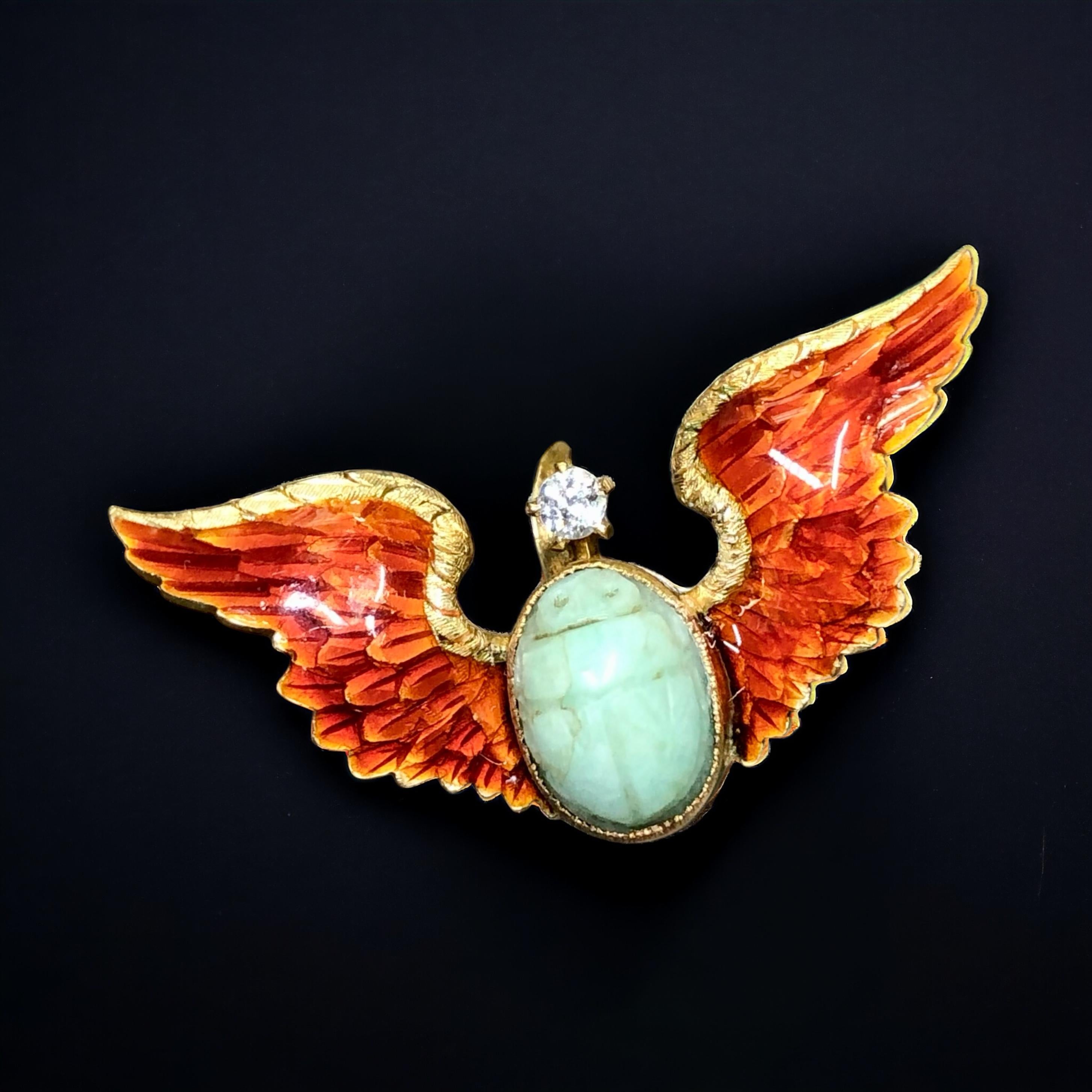 An absolutely exquisite, all original Art Nouveau-era pin done in 14K yellow gold and centered by a natural carved turquoise scarab and a .15ct old

mine cut diamond being I in color and Vs2 clarity and the wings have been finished in beautiful