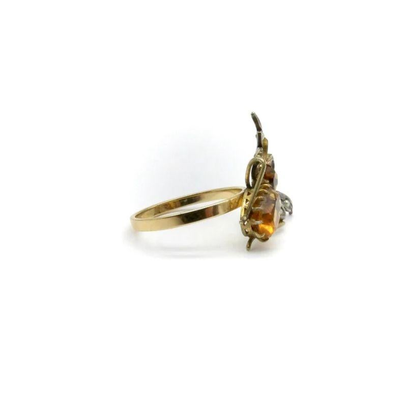 Perched on a 14k yellow gold band is a charming winged bug made of sterling silver, 9K gold, topaz, pearls, and a garnet. The bug dates to the 1900’s and is delicately made with superb craftsmanship. The topaz have a lovely honey color and the