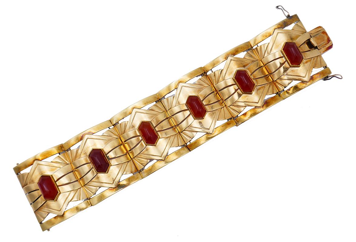 Very fine Art Nouveau bracelet created in the 1910s. 
Made of 14 karat yellow gold, the bangle features six hexagon shape cabochon carnelian. 
Measurements: 6 ¾” x 1 ½” (17 x 3.8 cm). Fits up to 6-3/4-inch wrist.
Weight: 47.9 grams.
Stamped with an