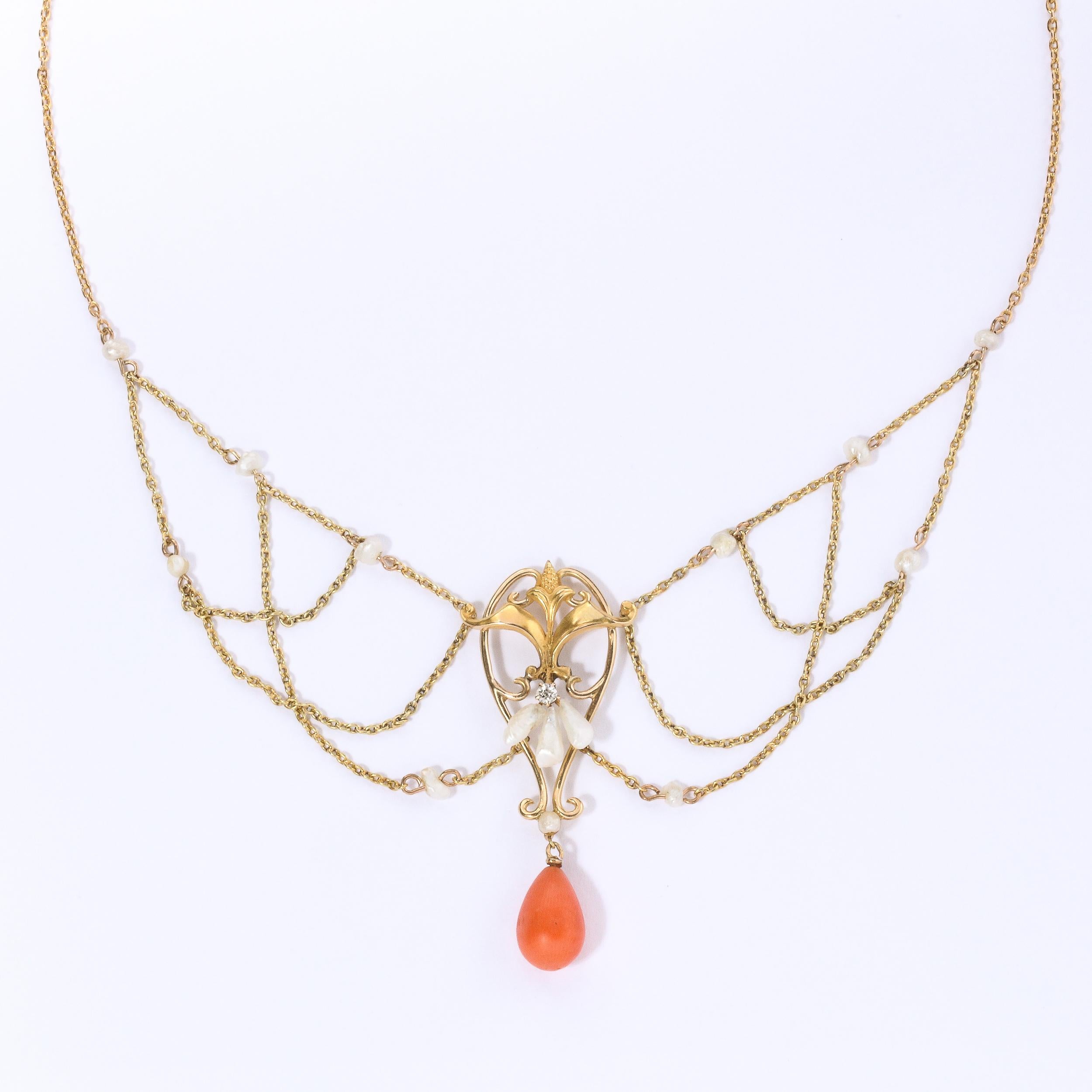 Art Nouveau 14k gold , pearl, coral and diamond swag necklace with central foliate form pendant accented by a single prong-set diamond and 3 natural pearl accents. Necklace terminates in a single polished pear-shaped coral drop pendant with seed