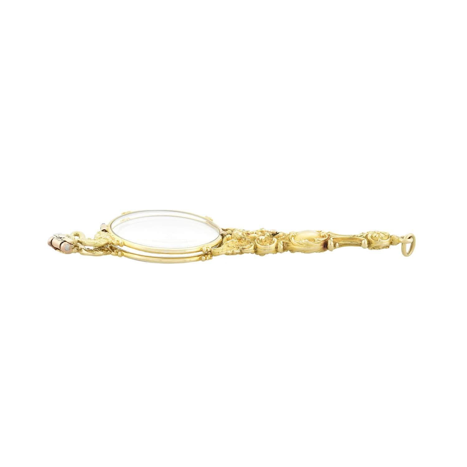 A spectacular lorgnette from the Art Nouveau (ca1900) period! Crafted in 14kt yellow gold, the piece consists of a pair of folding glasses encased in a breathtaking repousse lorgnette setting. The front and the back of the lorgnette are detailed