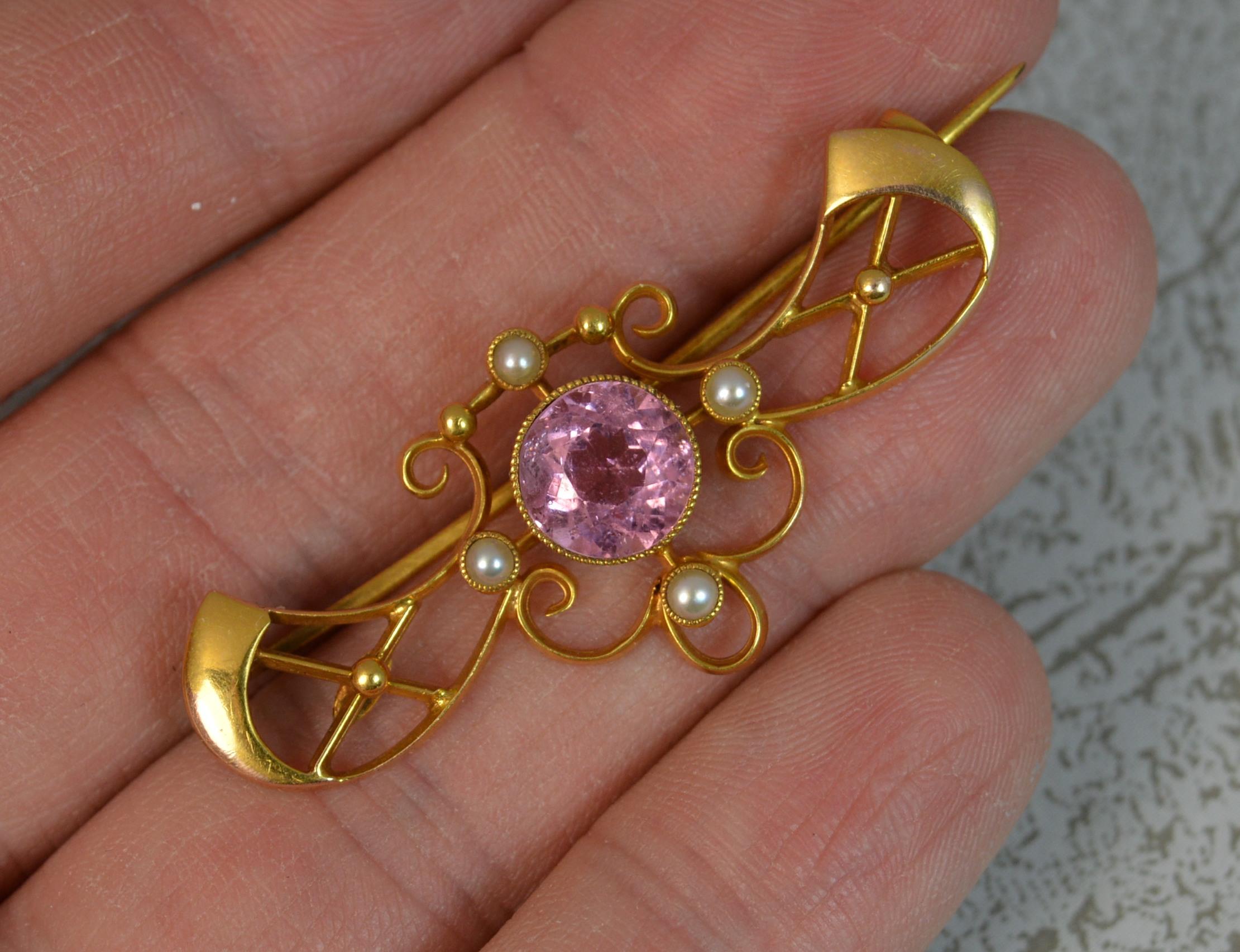 A fantastic quality and highly desirable Art Nouveau period brooch. c1905.
Solid 15 carat yellow gold example.
​Set with a large natural round cut pink tourmaline to centre, 8.5mm diameter in collet mount.
​The pierced design surrounding is set with