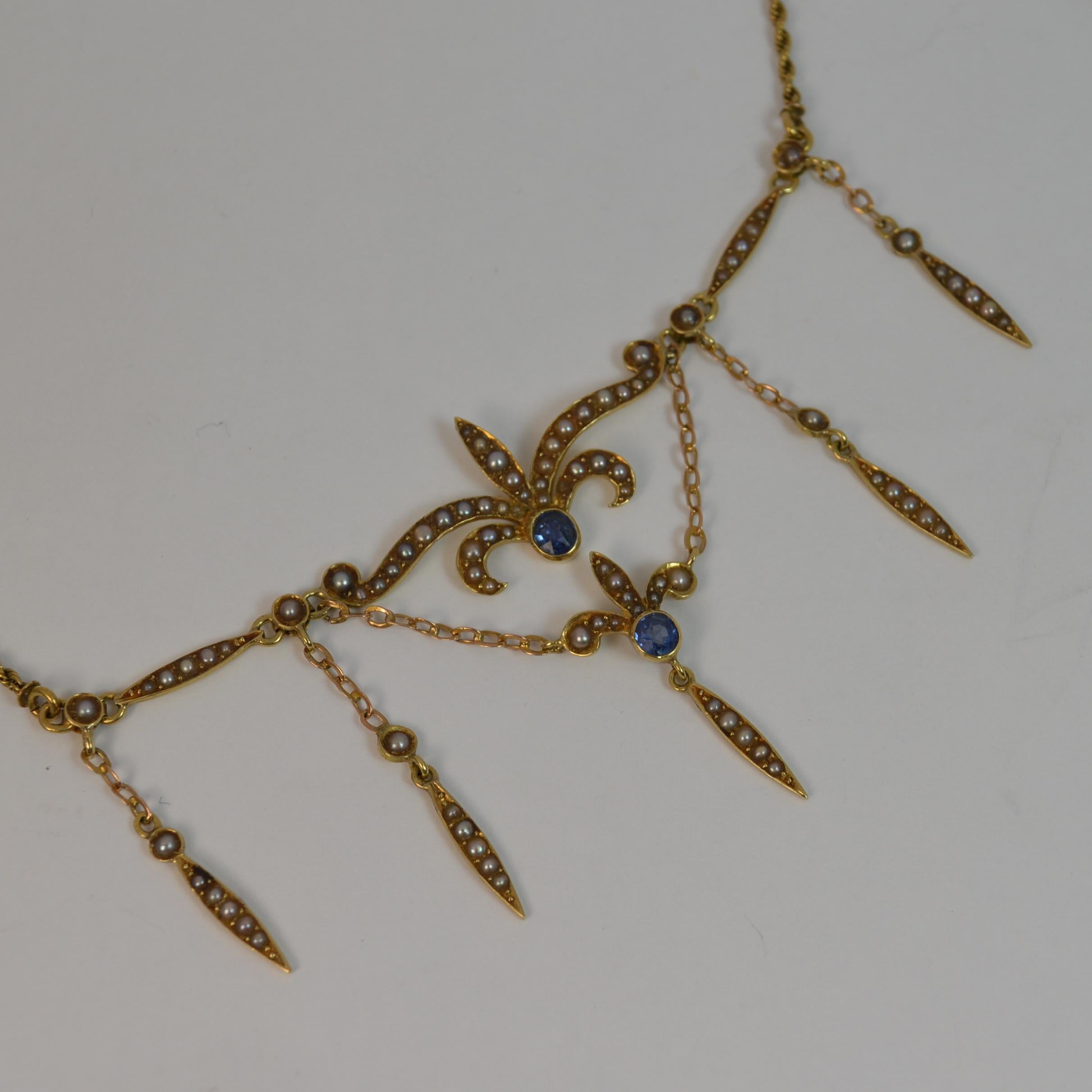
A superb quality ladies necklace chain pendant.

Solid 15 carat yellow gold example throughout.

Beautiful design with the seed pearl and sapphire with rope twist chain to each side.

True antique example, circa 1880.


CONDITION ; Very good. Clean