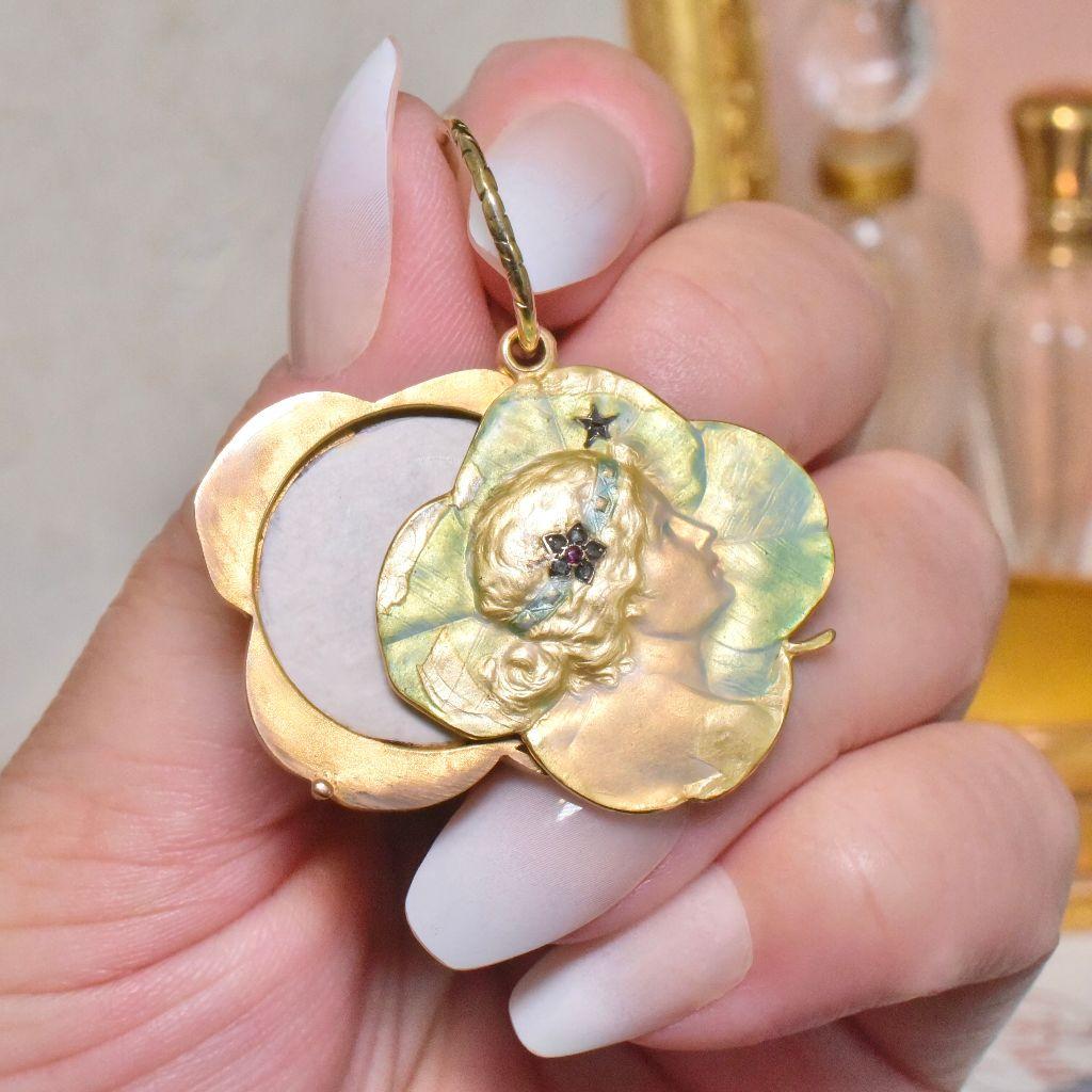 Designed as a symbolic four leaf Clover opening locket with a simple and easy to use ’slide to open’ mechanism and crafted from 15ct rose gold which has been superbly enamelled in pale yellow and green enamels to the front opening compartment, with