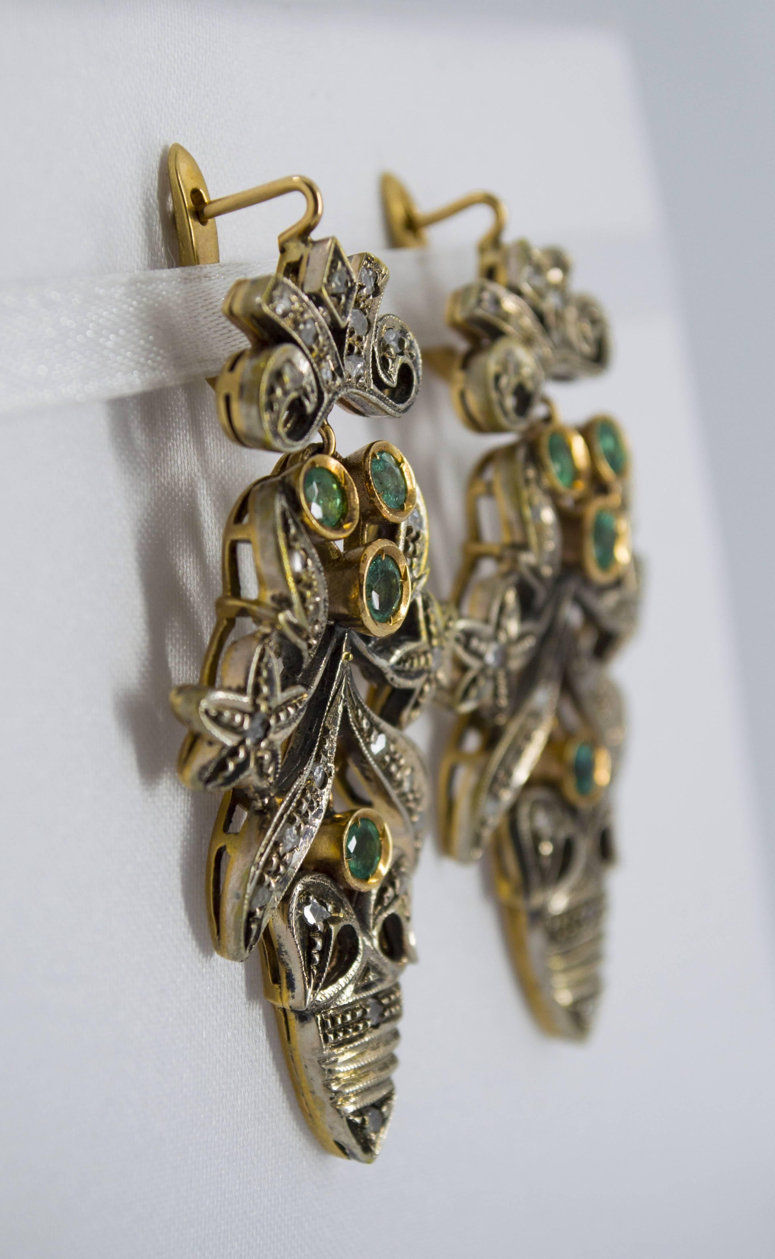 The earrings are made of 9K Yellow Gold and Sterling Silver and they've 1.60 carats of Emeralds and 0.60 carats of White Rose Cut Diamonds. 
The earrings are inspired by Art Nouveau so they're vintage reproduction.
We're a workshop so every piece is