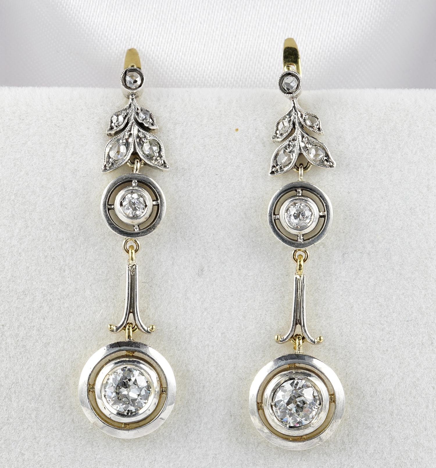 These rare and beautiful Art Nouvea drop earrings are 1900 ca
Crafted of solid 18 KT gold topped by silver
Graceful nature inspired design with a gorgeous top leaf leading to target shaped motifs, connected by a swirl bar
Larger Diamonds are two old