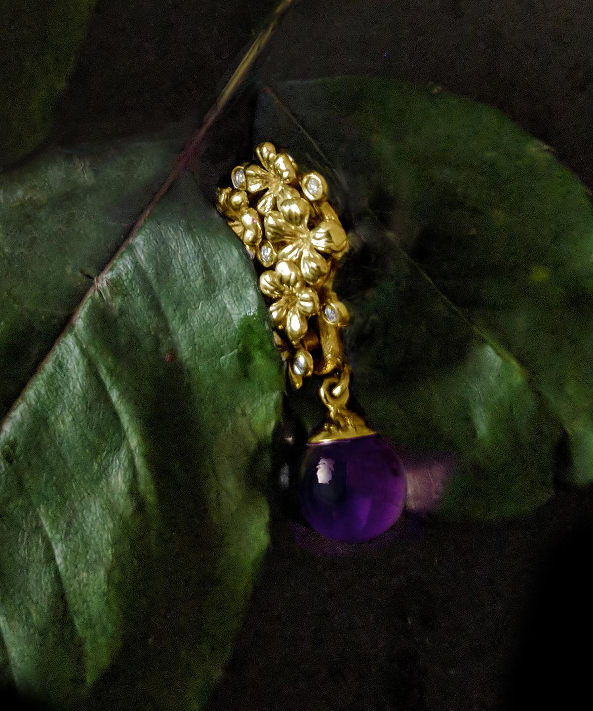 This Plum Blossom necklace pendant is a unique sculptural piece made from 14 karat yellow gold, encrusted with 5 round diamonds and a removable cabochon amethyst drop. We use top natural diamonds, VS clarity and F-G color, and work with a German