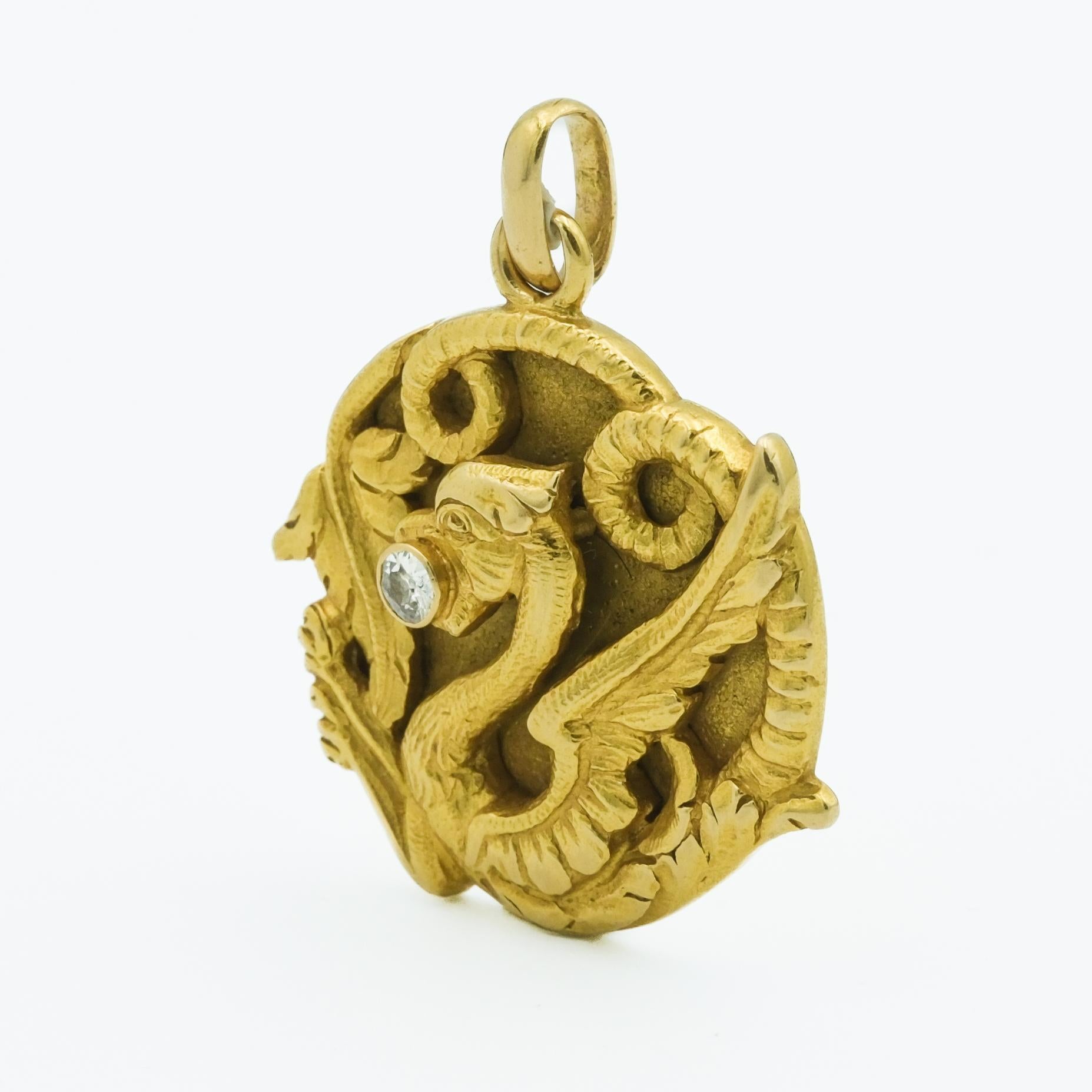 This 18 karat yellow gold dragon pendant is a masterpiece of the Art Nouveau period, renowned for its intricate design and enchanting historical significance. The pendant exhibits a stylized dragon, masterfully crafted to capture the mystical allure