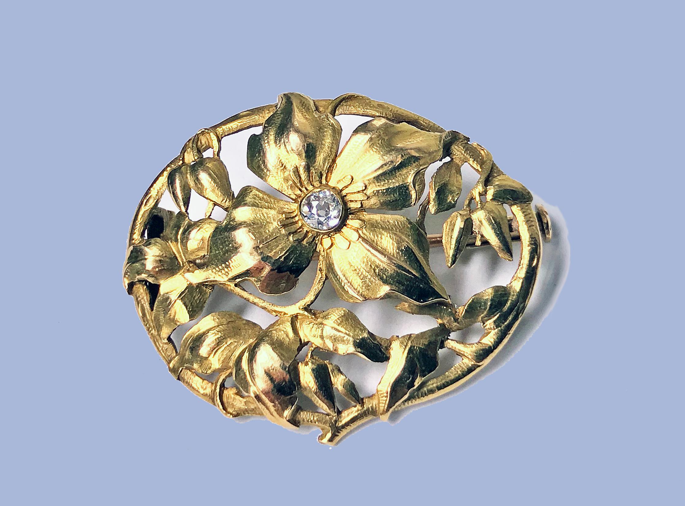 Art Nouveau 18K Diamond Brooch, C.1900. The brooch of oval pierced foliate design, the main floral petal set in the centre with a small old cut diamond. Trombone clasp to reverse. Measures: 3.00 x 2.00 cm. Item Weight: 4.30 grams. Acid tested 18K.