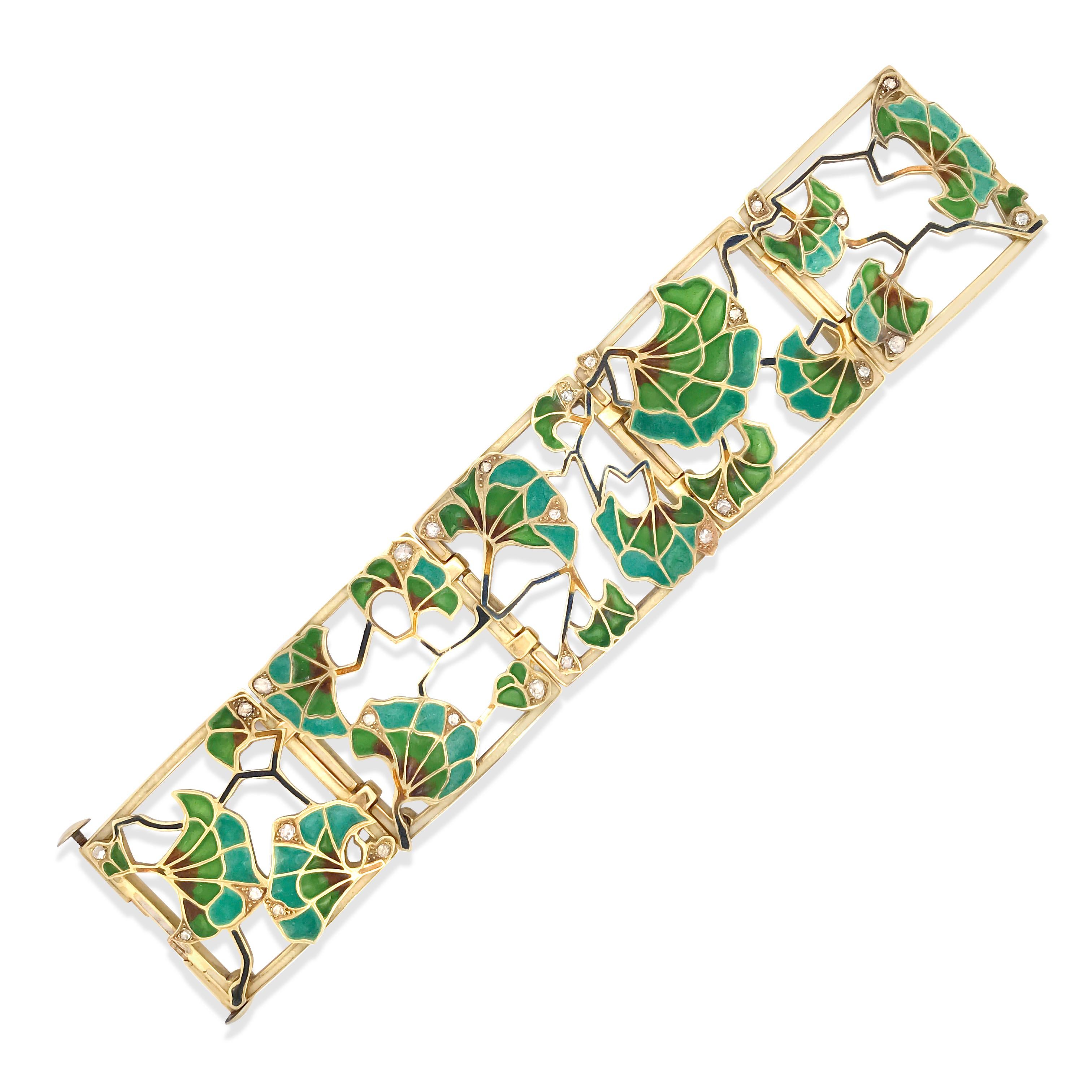 This Art Nouveau gold bangle bracelet is crafted in 18K yellow gold and embellished with lilypad-shaped blue, green, orange Plique-a-jour enamel, enhanced with 27 rose-cut diamonds weigh cumulatively 1.05 carats, mostly G-H-I/I clarity and some SI