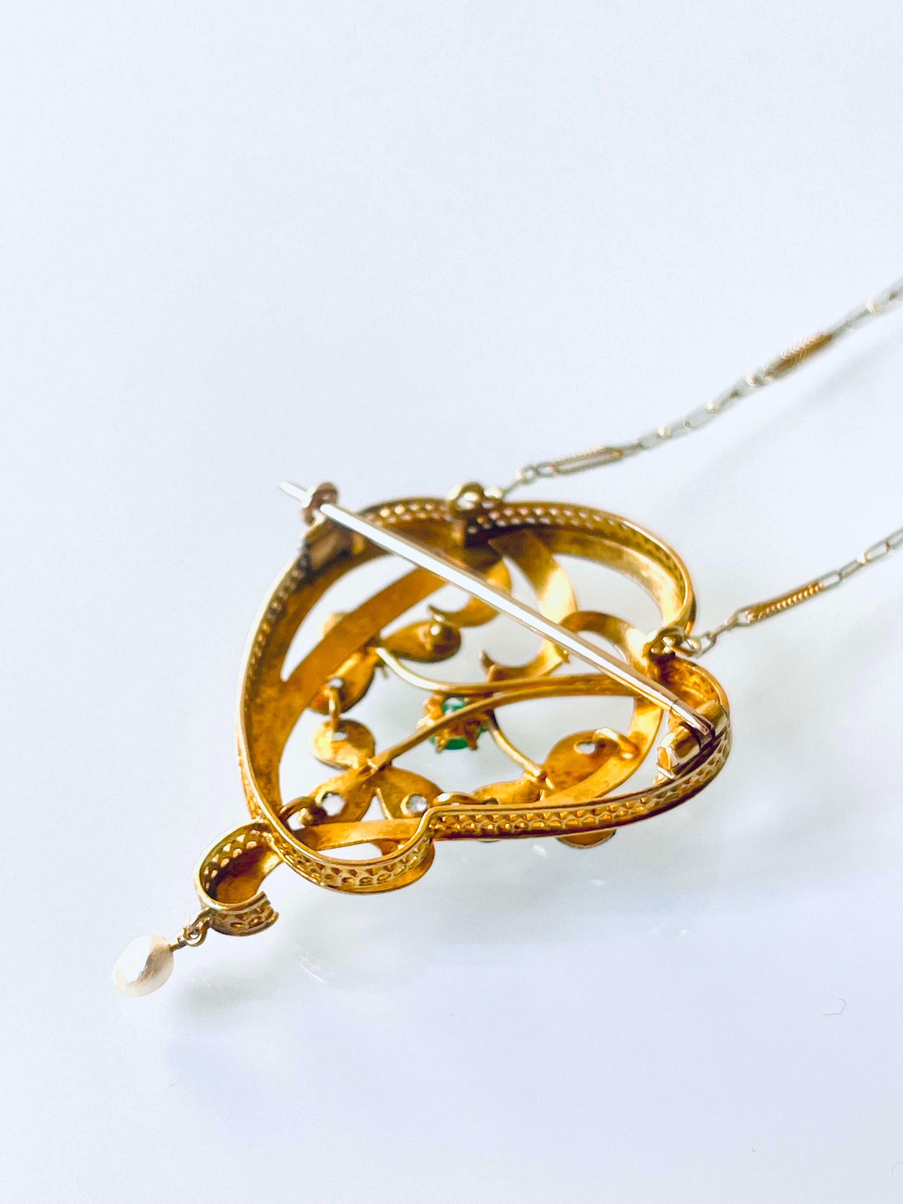 Antique Art Nouveau brooch pendant necklace lavaliere in 18 K matte YG  with an openwork scrolled foliate center set with rose cut diamonds, natural grass green emerald and suspending a natural saltwater pearl. This very well made piece is in a very