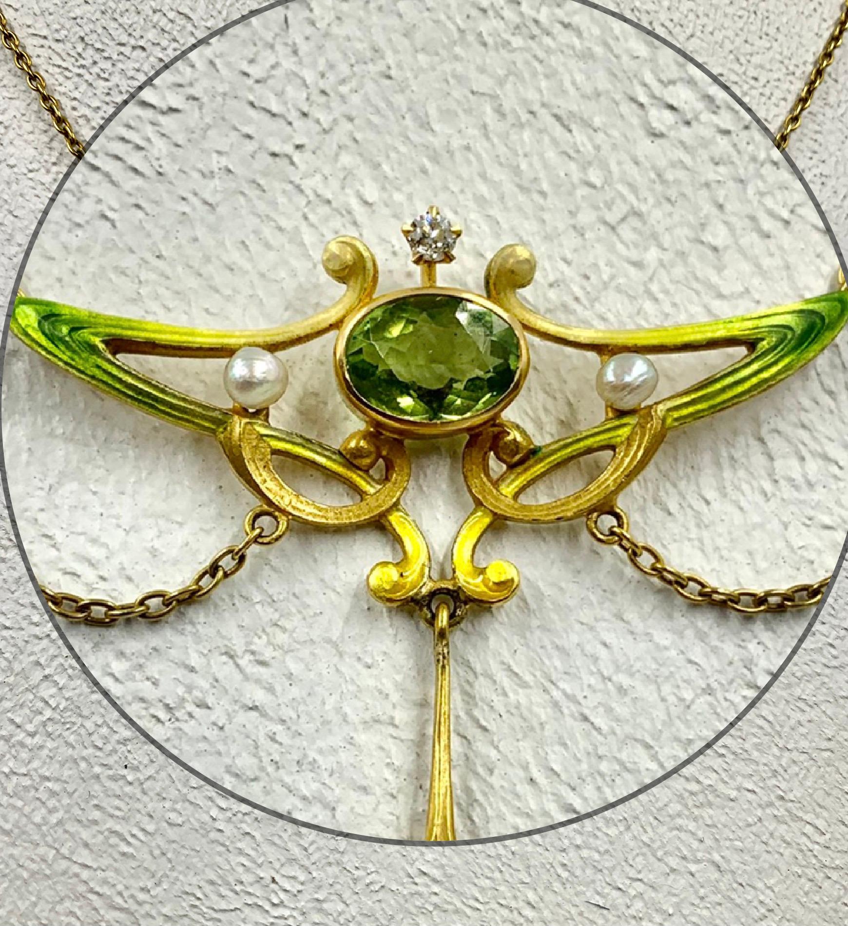 Beautiful Art Nouveau period 18K gold, Ombre enamel, faceted peridot, diamond and natural pearl necklace. With a central oval peridot measuring 9mm by 6mm, surrounded by fine stylized Art Nouveau undulating asymmetrical designs in ombre enamel