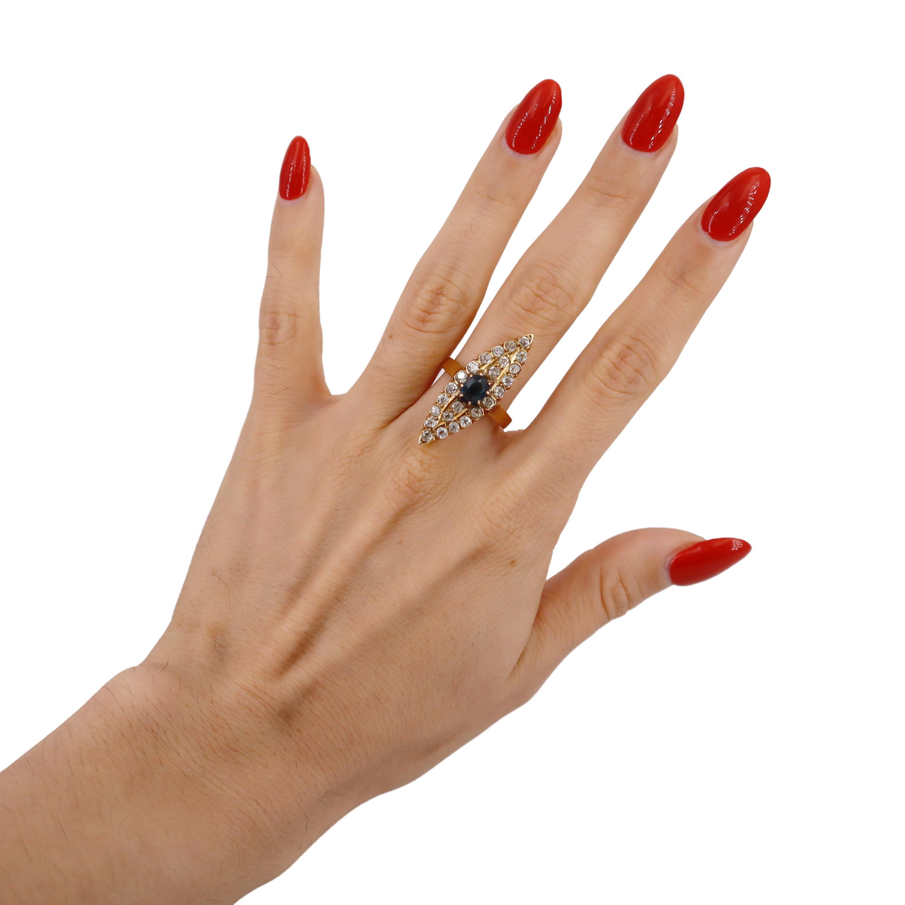 Introducing a stunning Art Nouveau Navette Ring, meticulously crafted in 18kt yellow gold. This exquisite piece features a captivating center Old cut Blue Sapphire weighing approximately 0.65 carats, radiating a deep, rich hue that embodies the