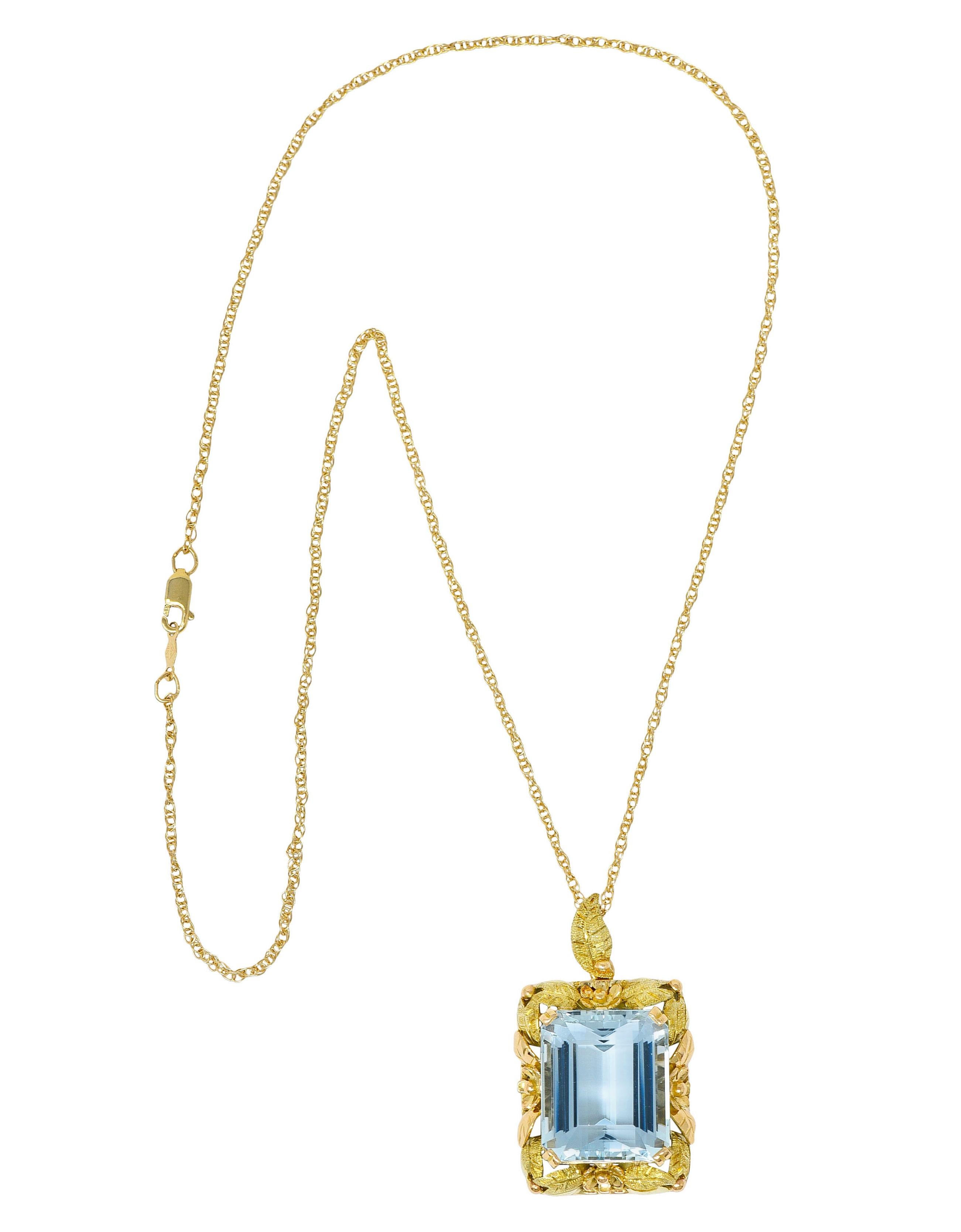 Featuring an emerald cut aquamarine weighing approximately 20.95 carats

Set by wide split prongs and exhibits transparent medium light sky blue color

Surrounded by flourishing florals and foliate of rose, green, and yellow gold

Suspending from a