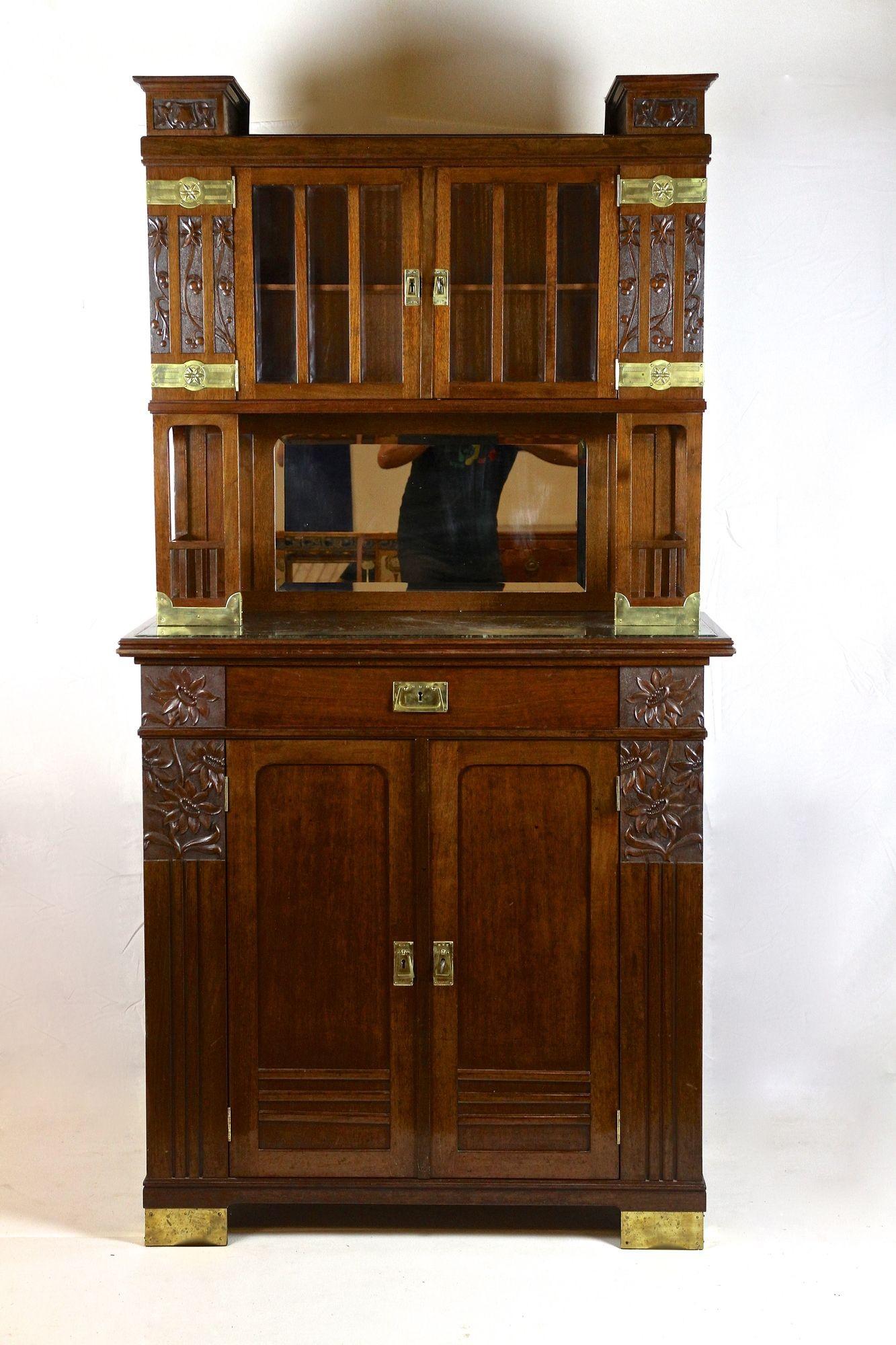 Remarkable Art Nouveau mahogany buffet cabinet from the period around 1910 in Austria. Consisting of two parts, this 20th century architectural cabinet impresses with its amazing details and straight shaped design. The lower part with the still