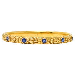 Art Nouveau 2.10 Carats Sapphire 14 Karat Yellow Gold Scrolling Floral Bangle