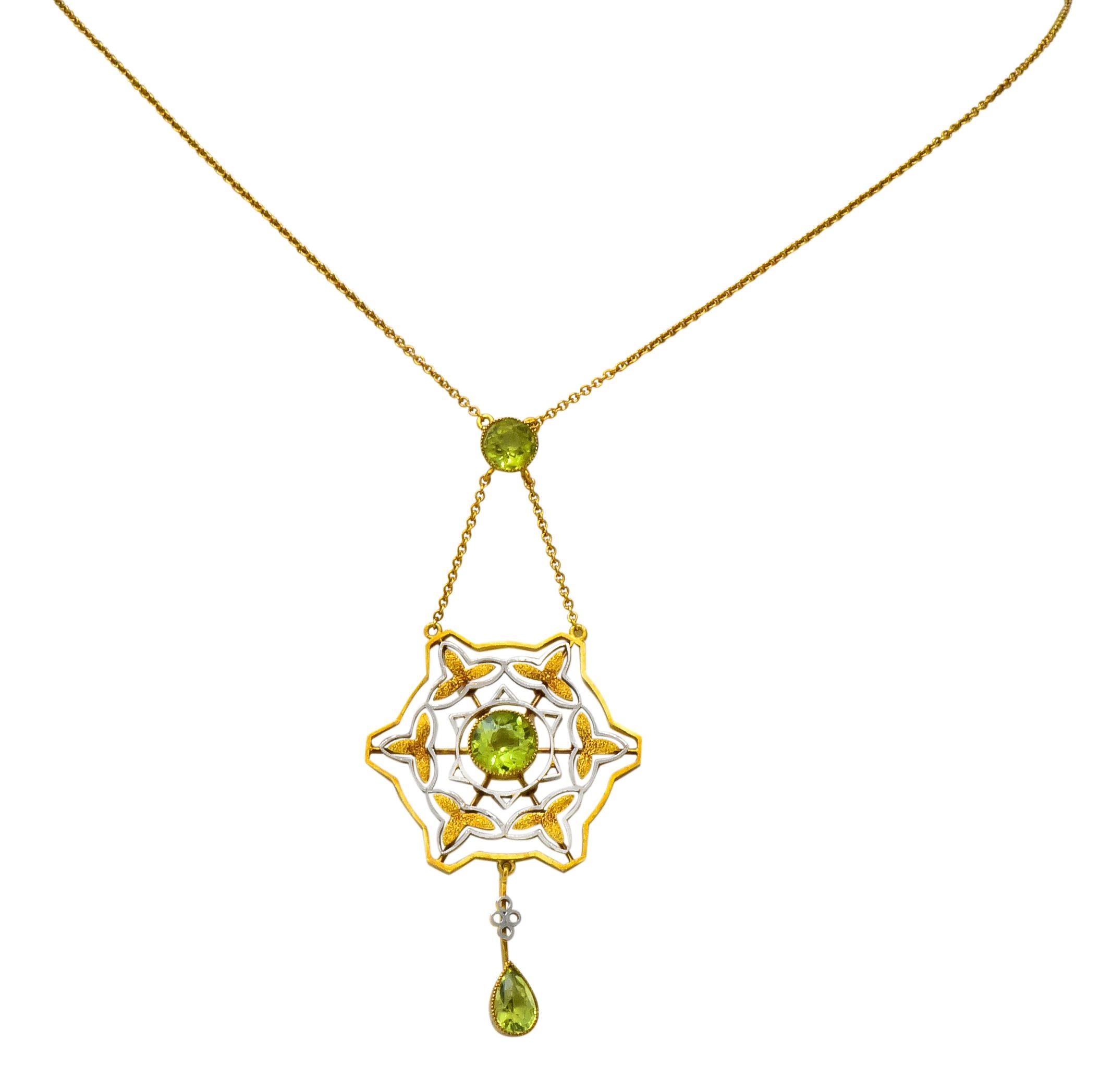 Featuring a round cut peridot with an open work station designed as a gold and platinum web that centers a second round cut peridot that then suspends a third pear cut peridot, all bezel set

Total peridot weight approximately 2.60 carats, bright