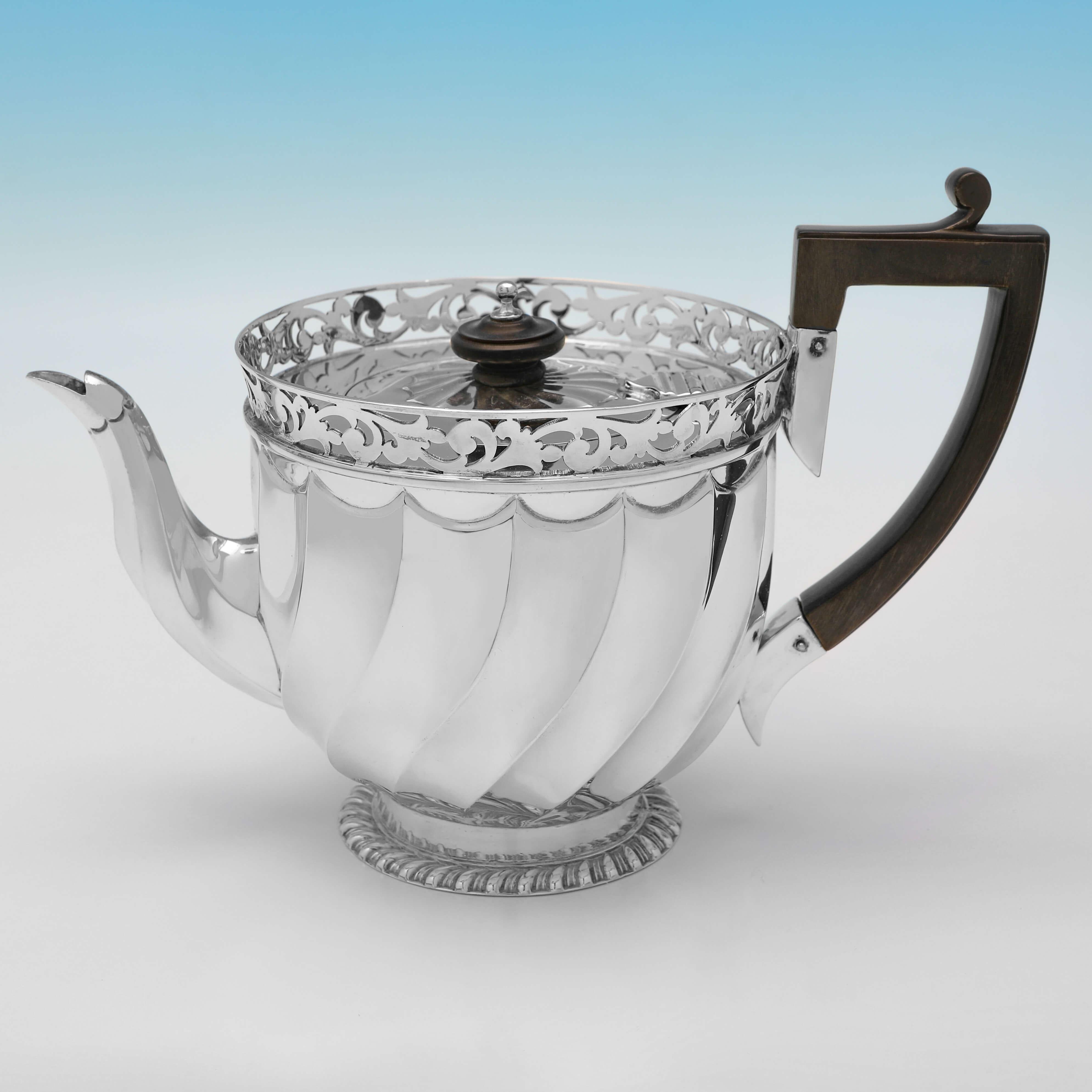 Hallmarked in London in 1902 by Wakely & Wheeler, this charming, Antique Sterling Silver Tea Set, is presented in its original box, and comprises a teapot, cream jug and sugar bowl, all with swirled panelling and pierced borders. 

The teapot