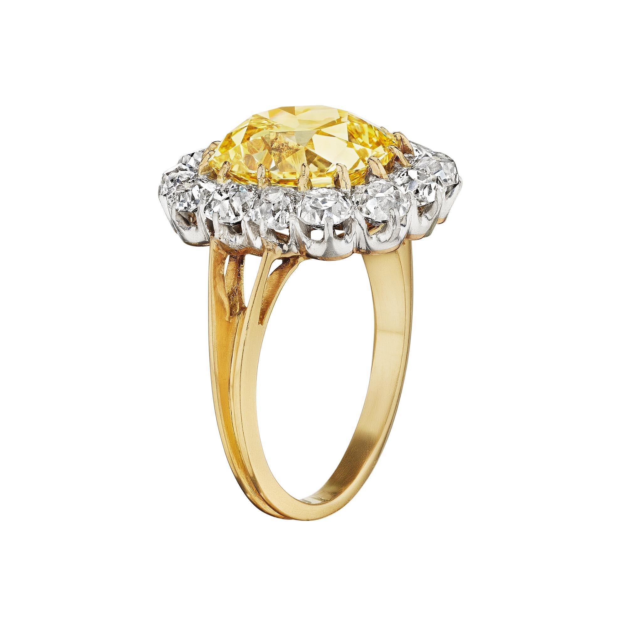 Let the sun shine in with this Art Nouveau 4.23 carat old mine brilliant cushion cut fancy intense yellow diamond ring.  The scintillating center yellow diamond is surrounded by a total of 1.50 carats of fiery round cut white diamonds creating a