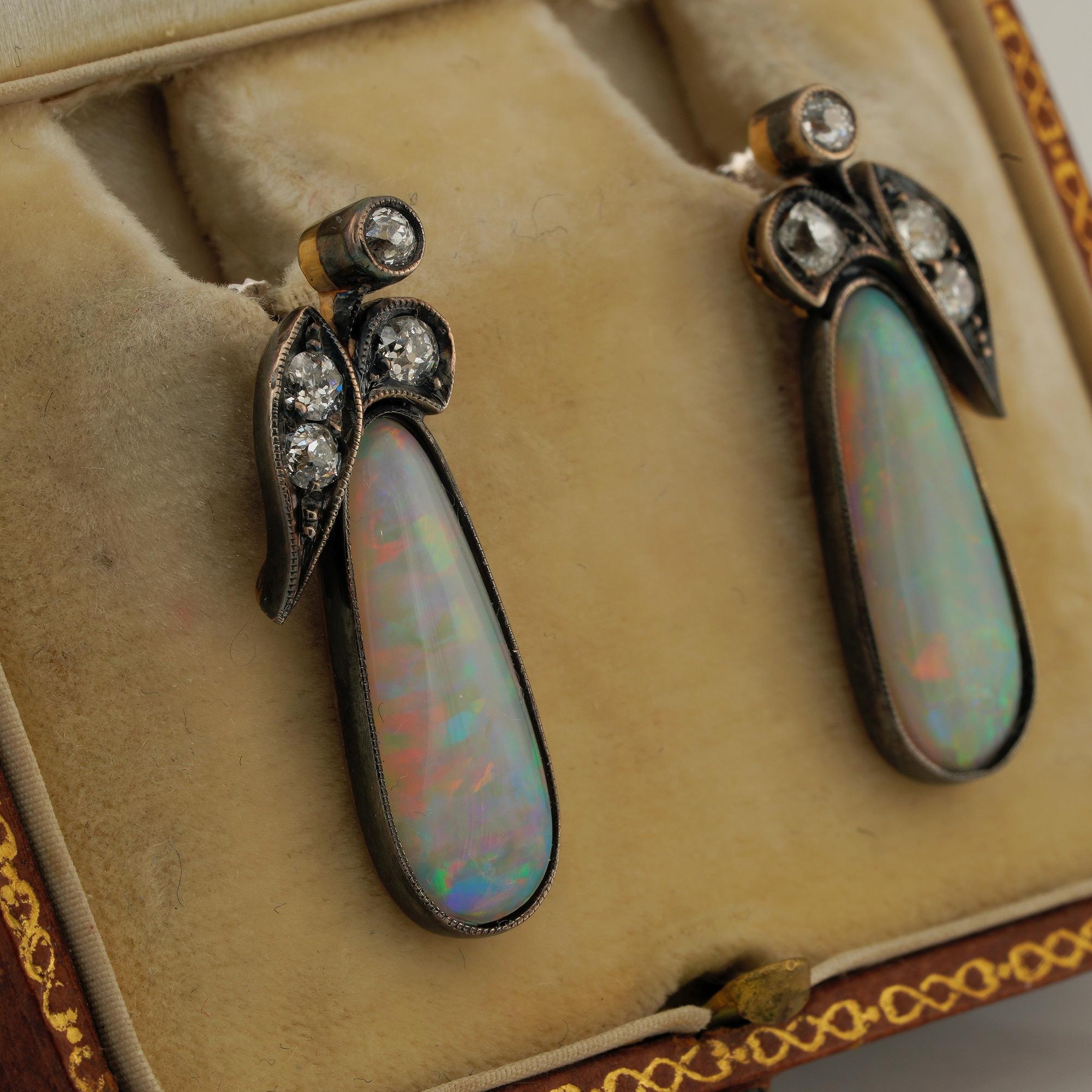 These very pretty antique earrings are beginning of last century, 1900 ca
Hand crafted of pale yellow solid 18 KT topped by silver
Art Nouveau leaf design top adorning two custom cut natural Opal of approx 5.00 CT – (19 x 7 mm. average)
Opals