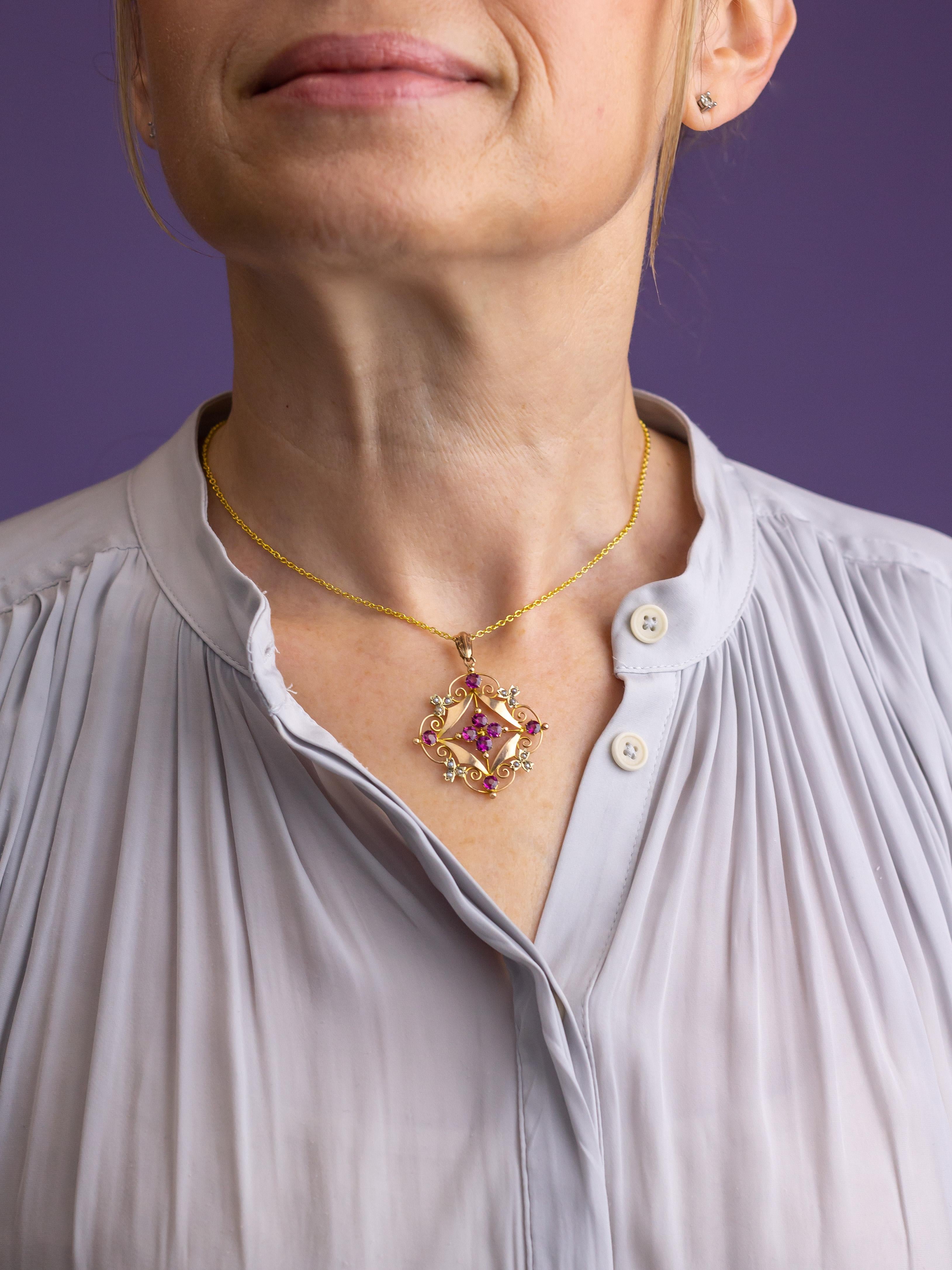 This Art Nouveau pendant has been crafted from 9 karat yellow gold and has been set with pink tourmalines and cultured seed pearls. The pendant centres on four brilliant cut pink tourmalines and is surrounded by a decorative border of gold scroll