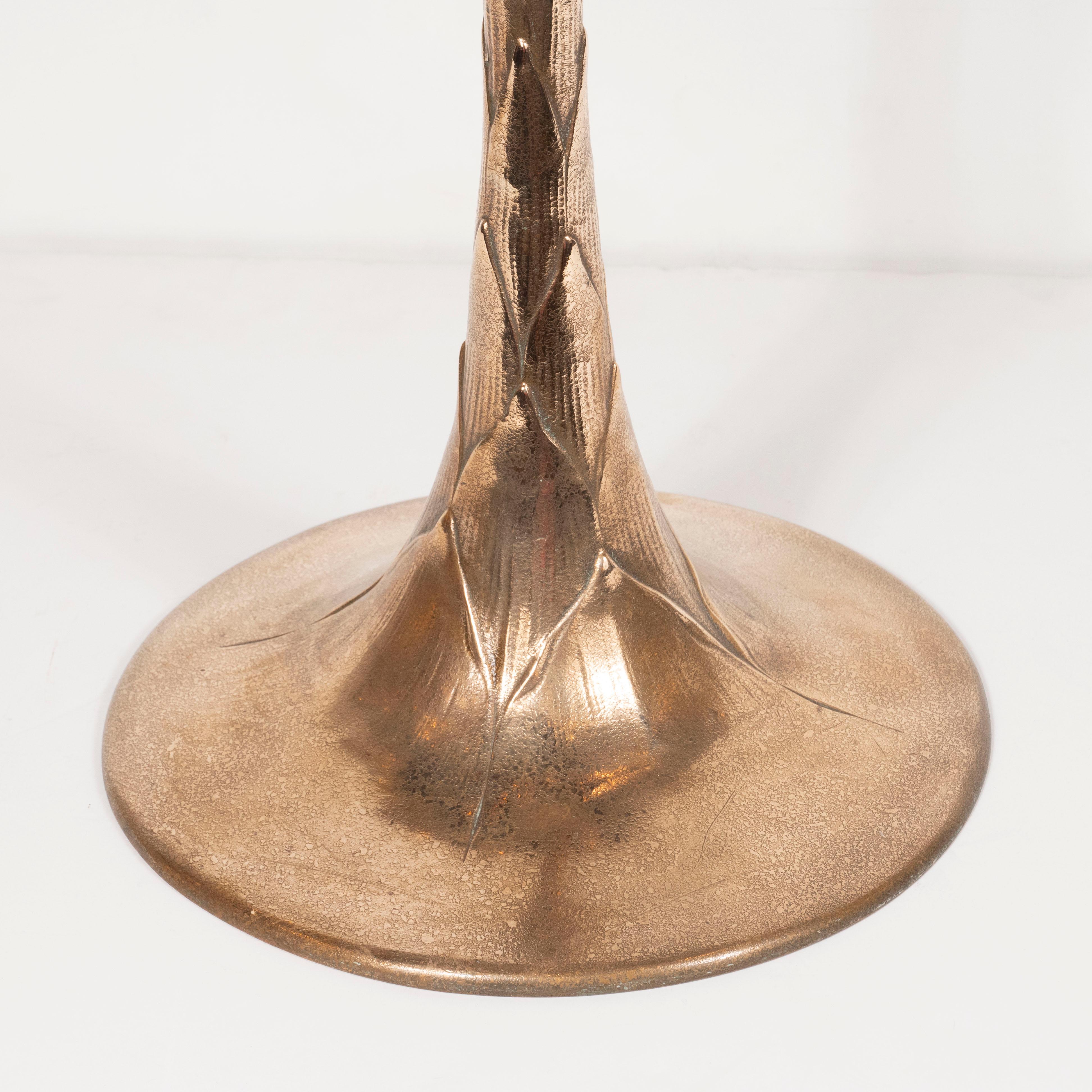 This beautiful standing bronze ash tray was realized by the fabled American design firm, Tiffany & Co. (then Tiffany Studios), in the United States circa 1905. The piece features a circular base that tapers as it ascends and offers a geometric