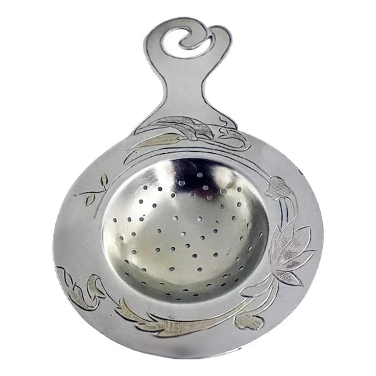 Rare Art Nouveau Aesthetic sterling tea strainer, probably American C.1890. Decorated with light vermeil floral leaf decoration surround to welled pierced bowl. Stamped Sterling on reverse. Measures: 5.125 x 3.00 inches. Total item weight: 40 grams.