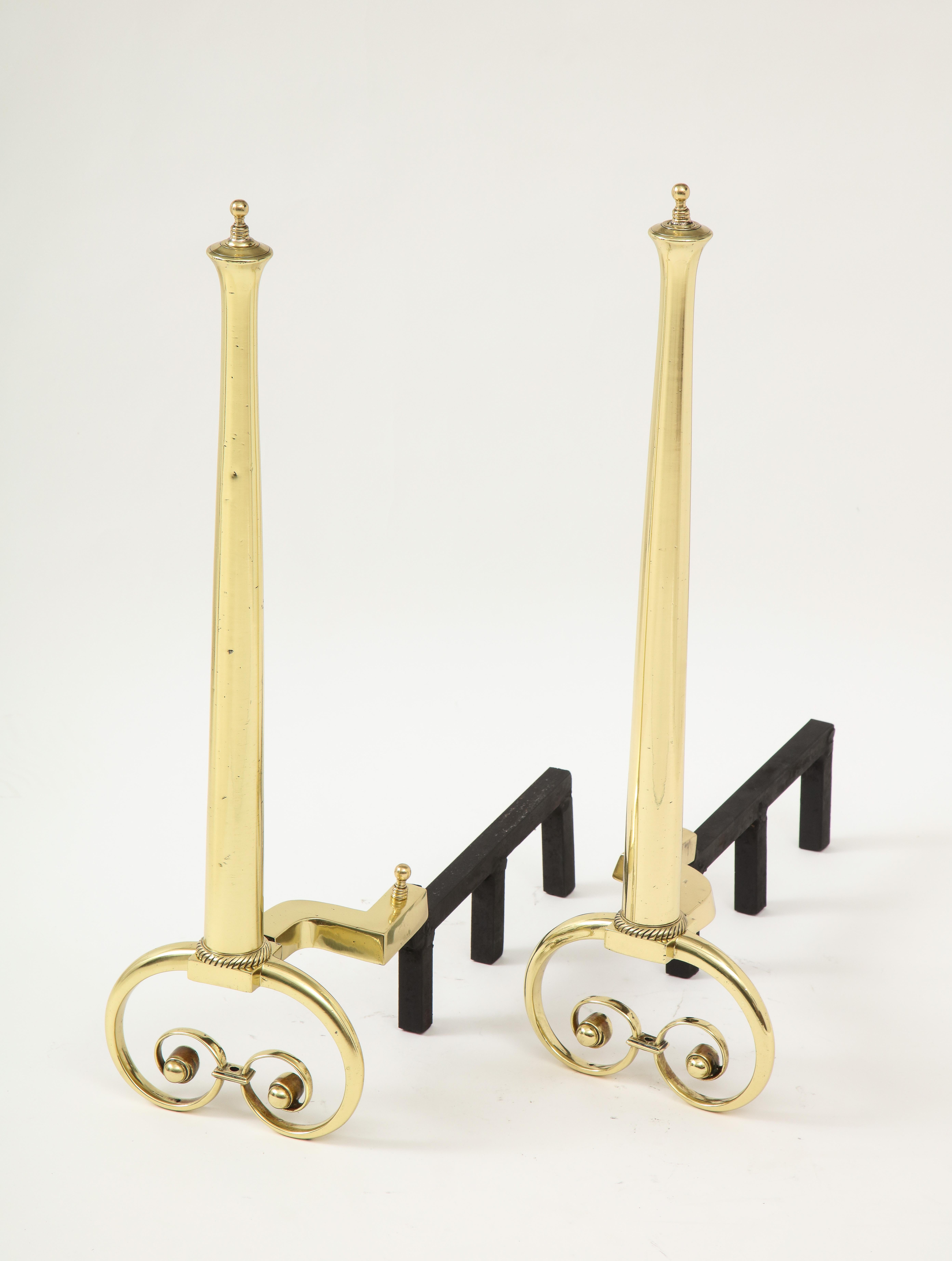 Pair of tapering brass Art Nouveau andirons ending with scrolled feet, circa 1930s.