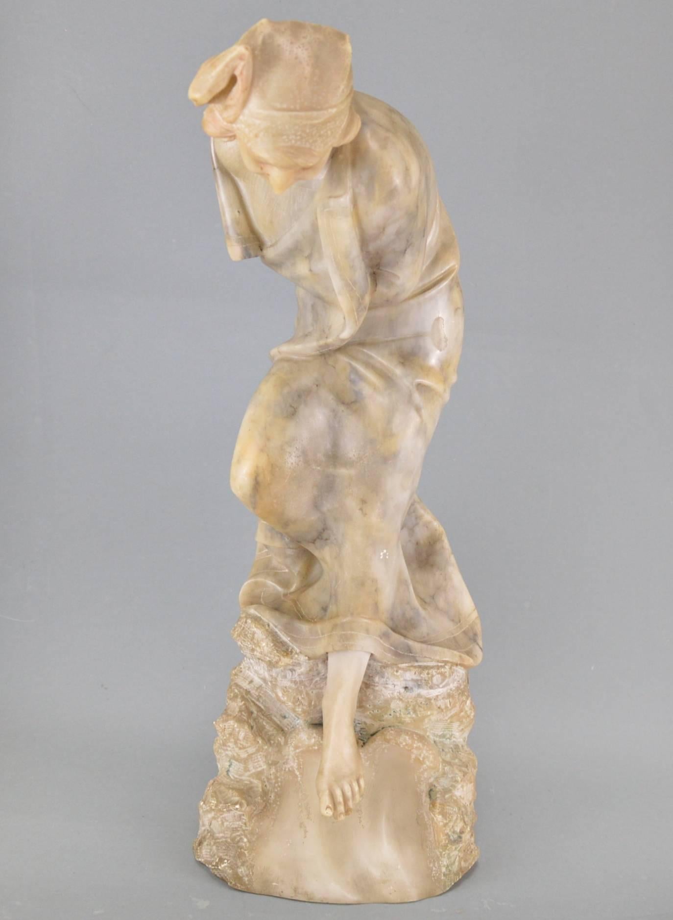 Art Nouveau alabaster sculpture, woman on a rock, late 19th century.
Measures: Height 63 cm.