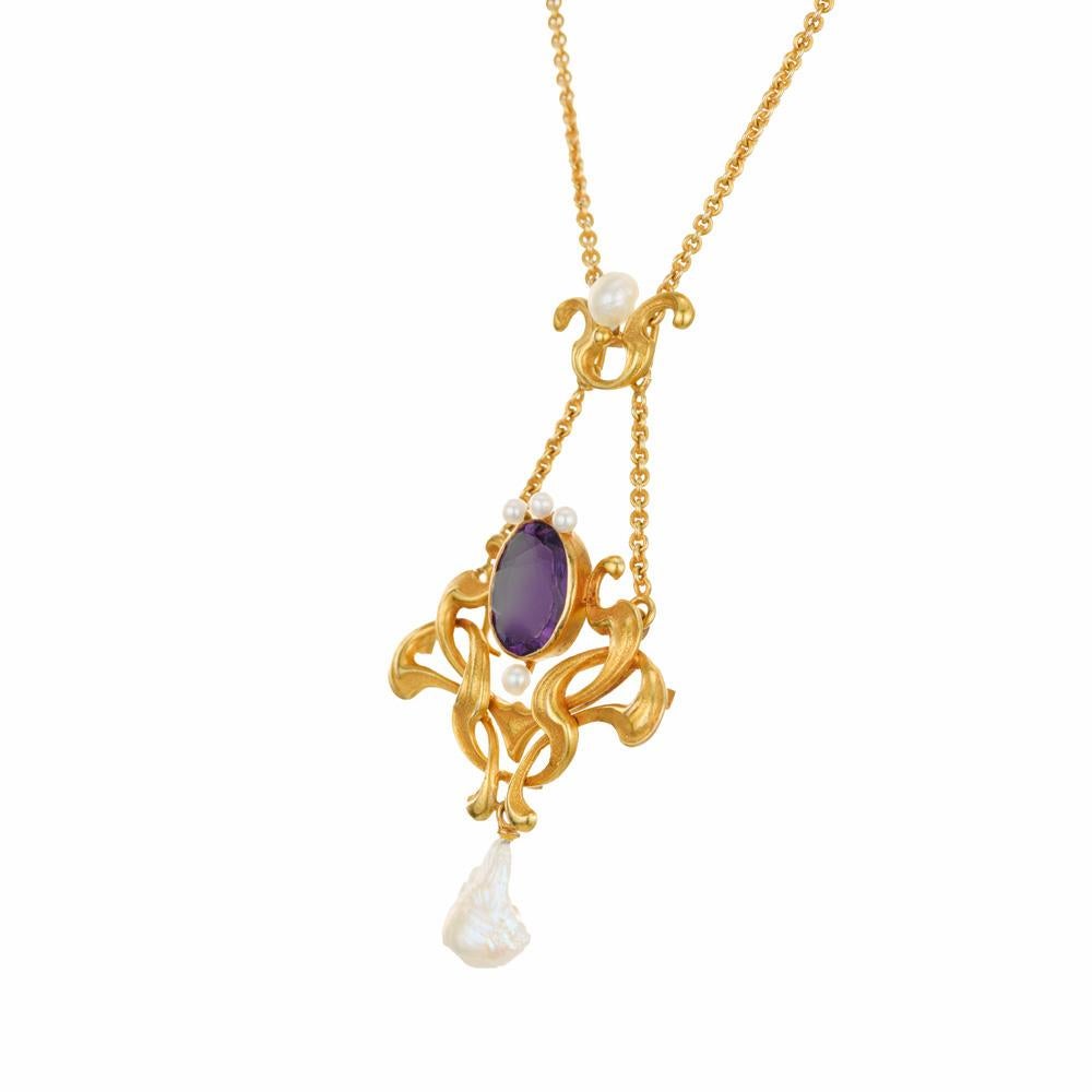 Amethyst  and pearl pendant necklace. Oval Amethyst center stone mounted in a 10k yellow gold bezel pendant setting. Accented with 5 freshwater natural pearls and 1 white baroque freshwater pearl. GIA certified only one pearl. Original circa 1905.
