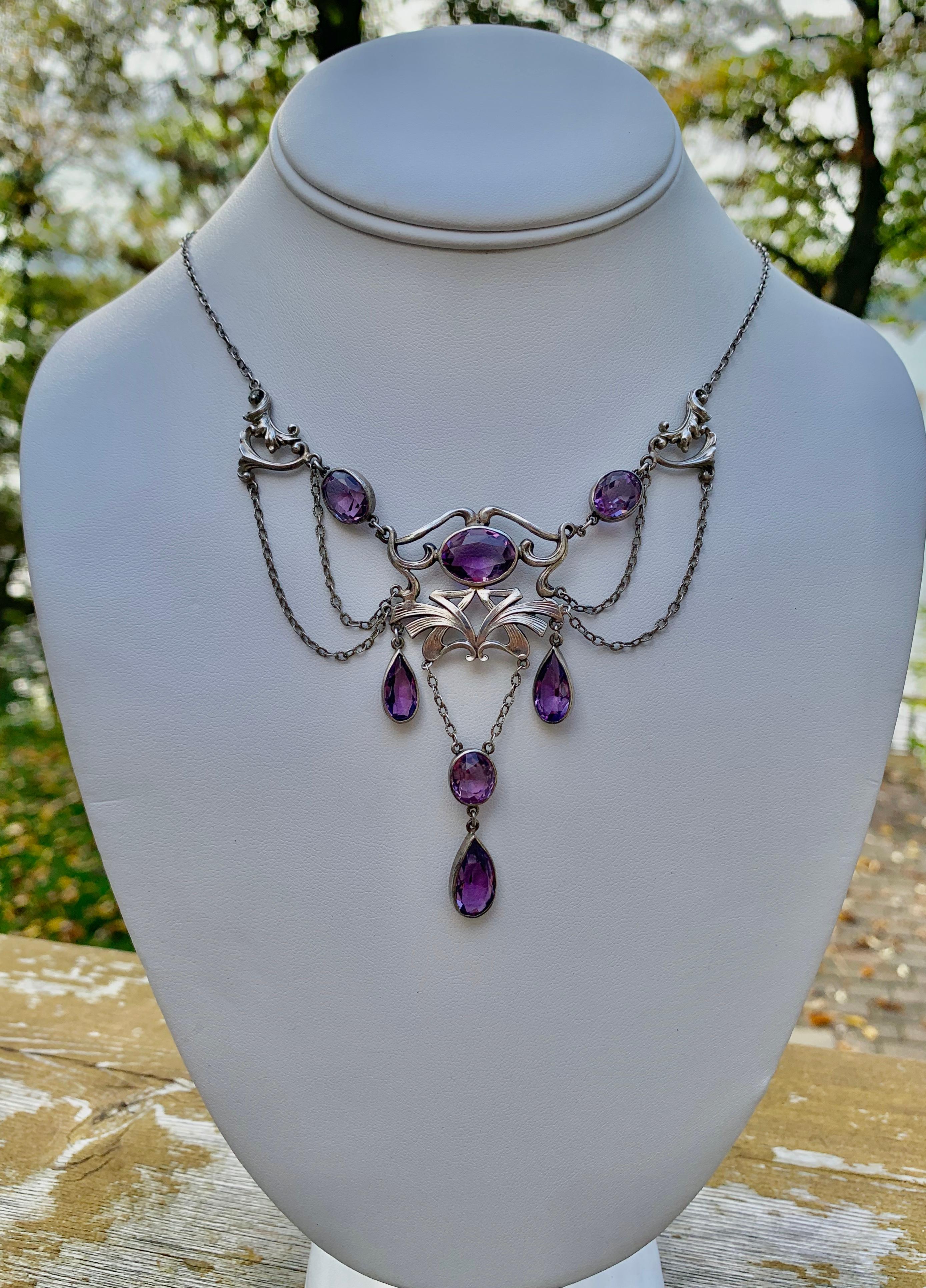 THIS IS A RARE MUSEUM QUALITY ART NOUVEAU - BELLE EPOQUE FESTOON NECKLACE WITH THE MOST GORGEOUS NATURAL OVAL AND PEAR SHAPE AMETHYST GEMS SET IN A GORGEOUS SCROLL ACANTHUS LEAF MOTIF SETTING IN AN OPEN WORK FESTOON SWAG DESIGN IN STERLING SILVER