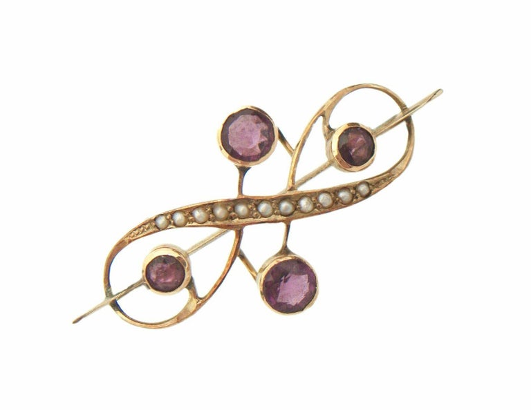 Art Nouveau 10K yellow gold brooch/pin - polished gold finish - hand made featuring organic scrolling tendrils and cross bar - set with four round faceted amethyst paste/glass (bezel set - 2 x 5 mm and 2 x 3.5 mm) - also set with eleven seed pearls