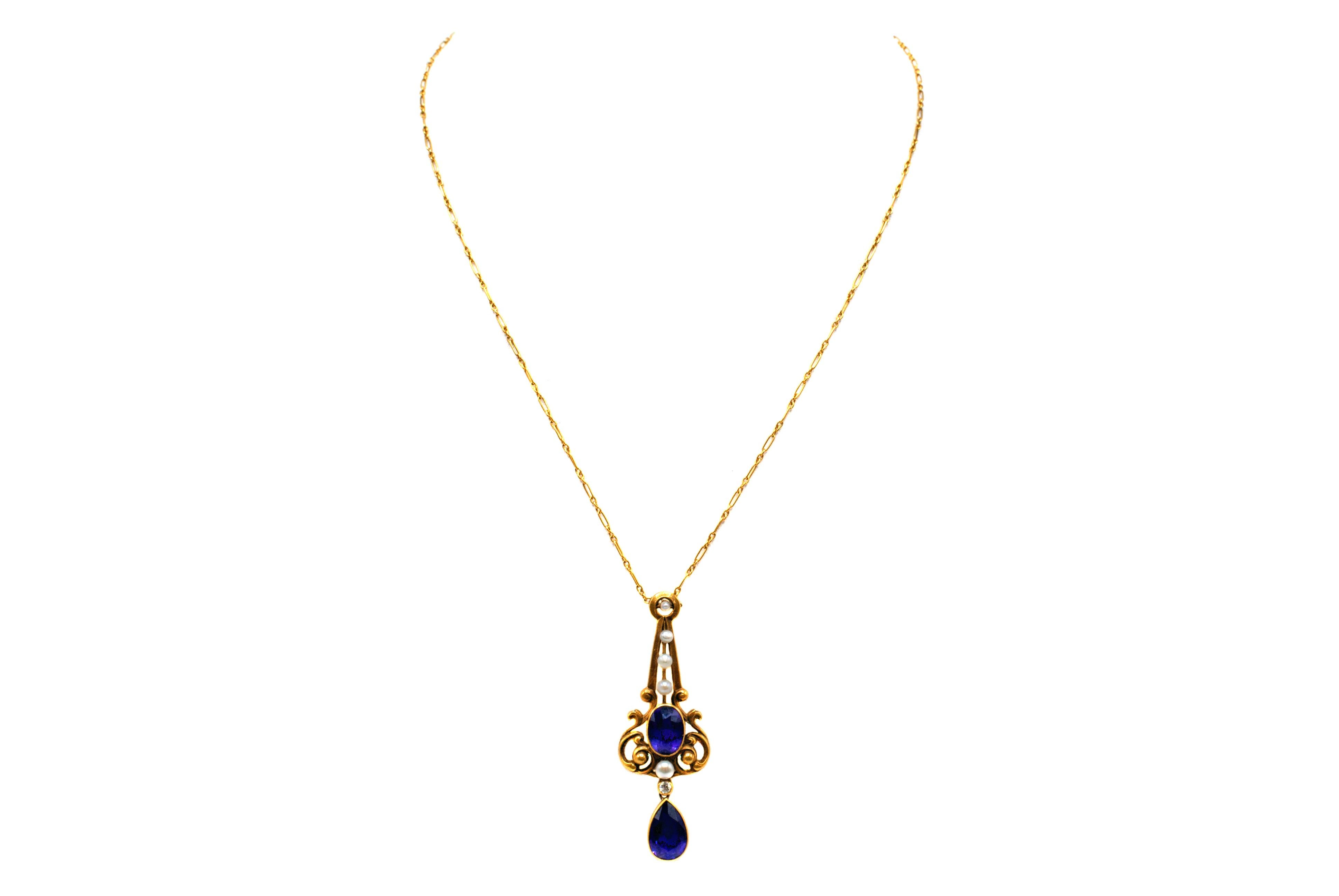 This unique Art Nouveau pendant from ca. 1890 features 2 deep velvety purple amethysts and 5 seed pearls accented with one round bright white old cut diamond. The beautifully handcrafted pendant exhibits the typical designs from this era with