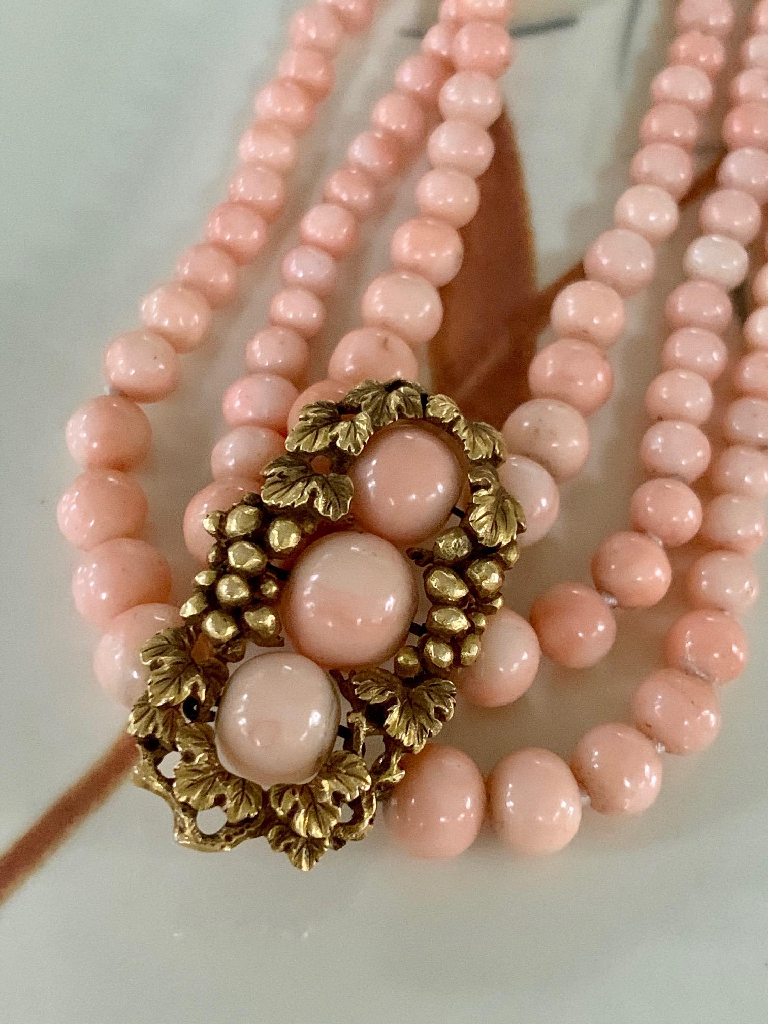 This beautiful triple strand necklace features Angel Skin Coral.  The color of this Coral is just so lovey and can easily be worn with colors of any kind.  The Coral beads are graduated in size from 3 to 9mm.  The clasp is 14k yellow Gold as is the